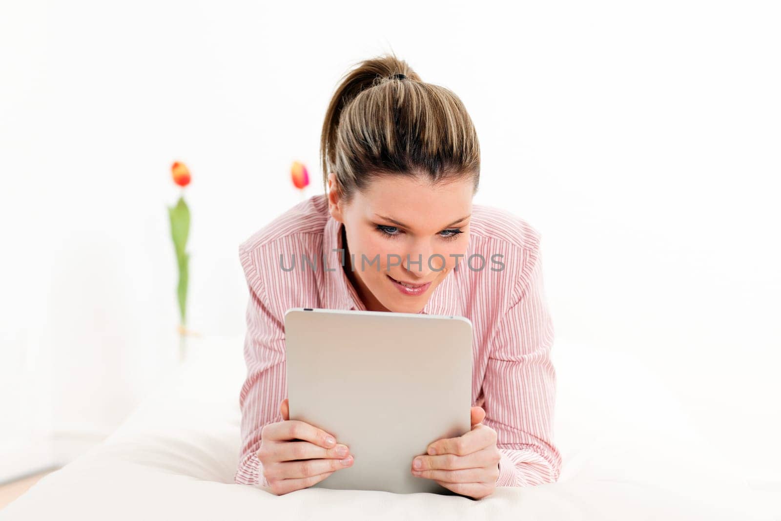 young woman with tablet on sofa at home