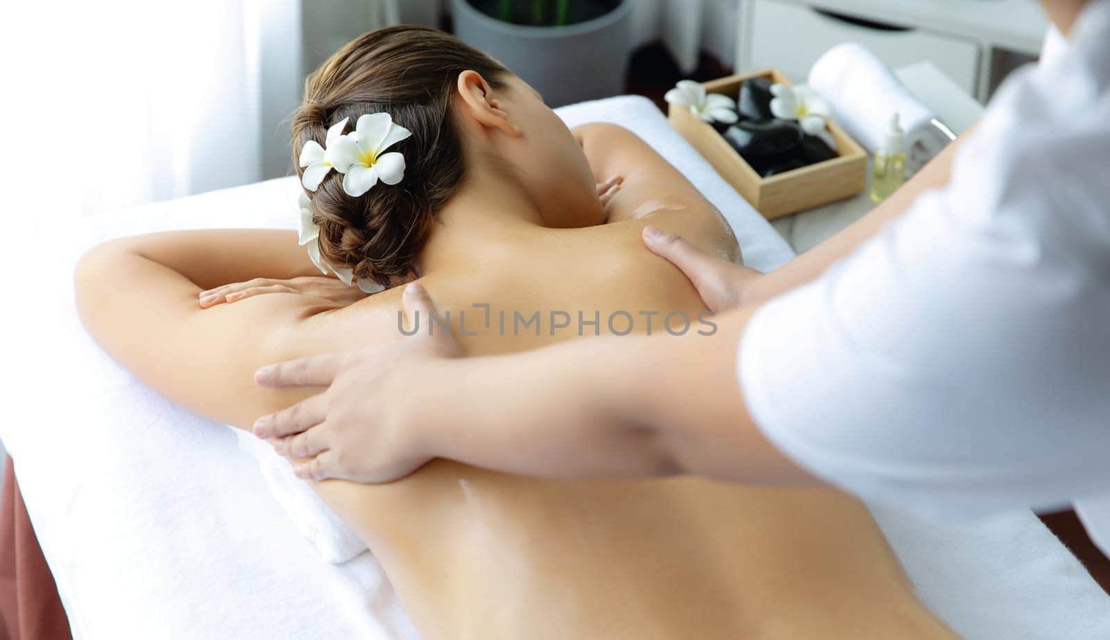 Caucasian woman customer enjoying relaxing anti-stress massage. Quiescent by biancoblue