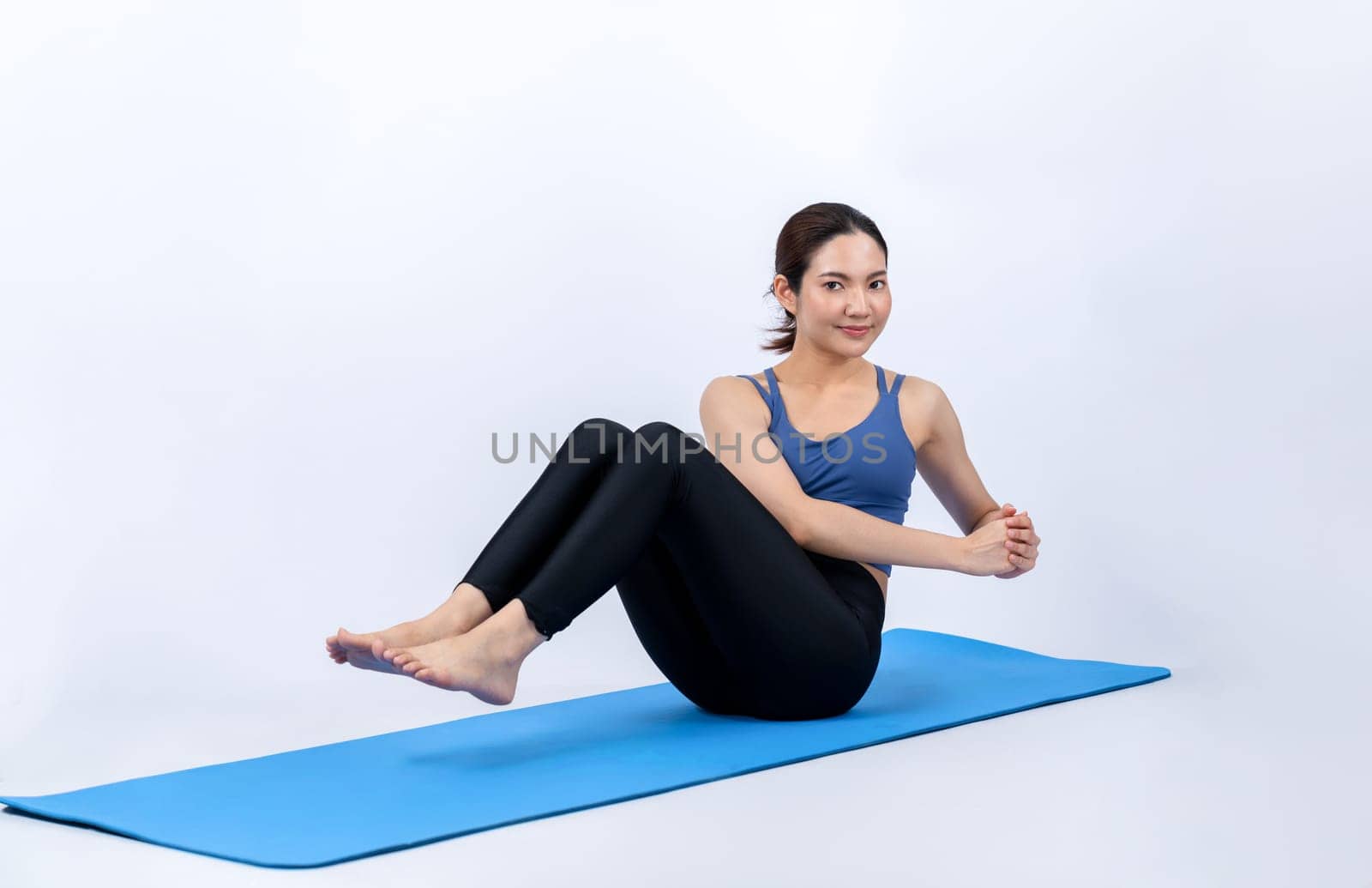 Asian woman in sportswear doing crunch on exercising mat. Vigorous by biancoblue