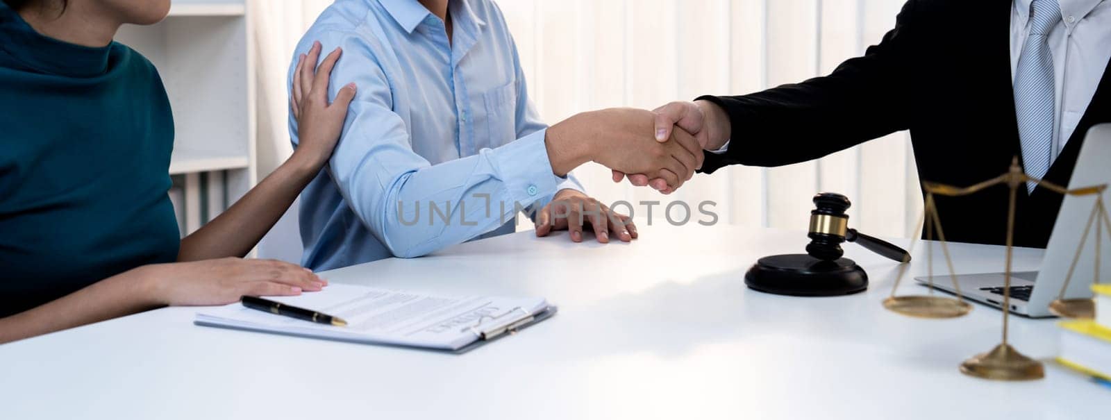 Couple shake hand with their lawyer after successfully completing marriage certification and receiving legal marriage consultation assistance from law firm. Panorama Rigid