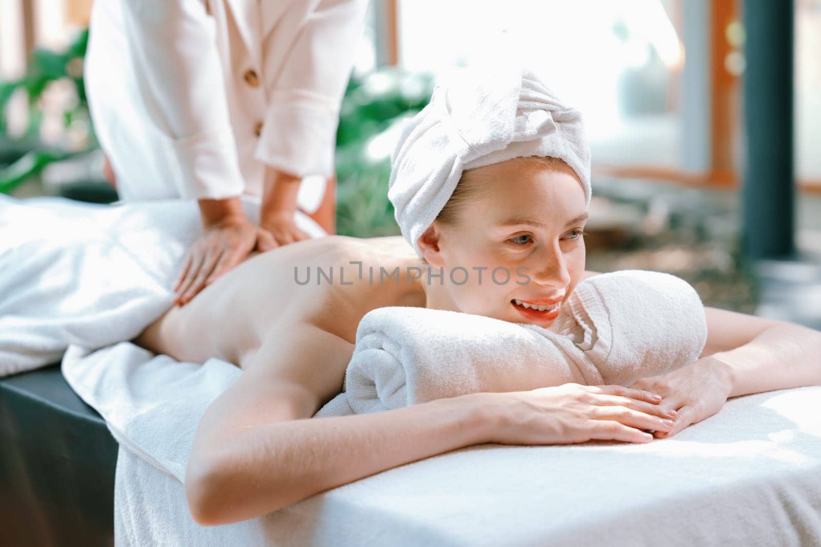 Beautiful young woman received a back massage on a spa bed. Tranquility. by biancoblue