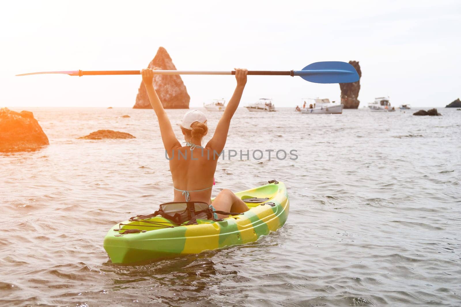 Kayaking. Travel adventure kayak on the tropical sea on a sunny day. Woman rowing a canoe.