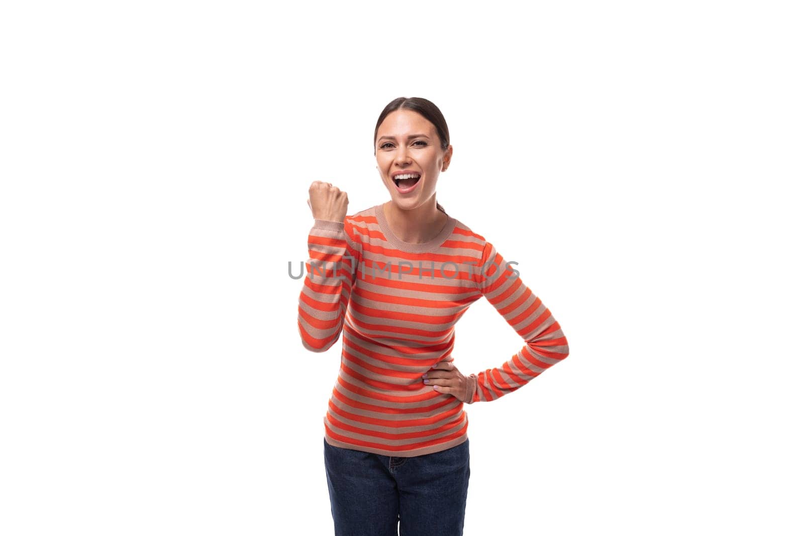 young joyful european slender woman dressed in casual clothes is experiencing happiness.