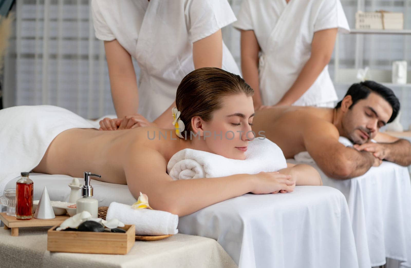 Caucasian couple customer enjoying relaxing anti-stress massage. Quiescent by biancoblue