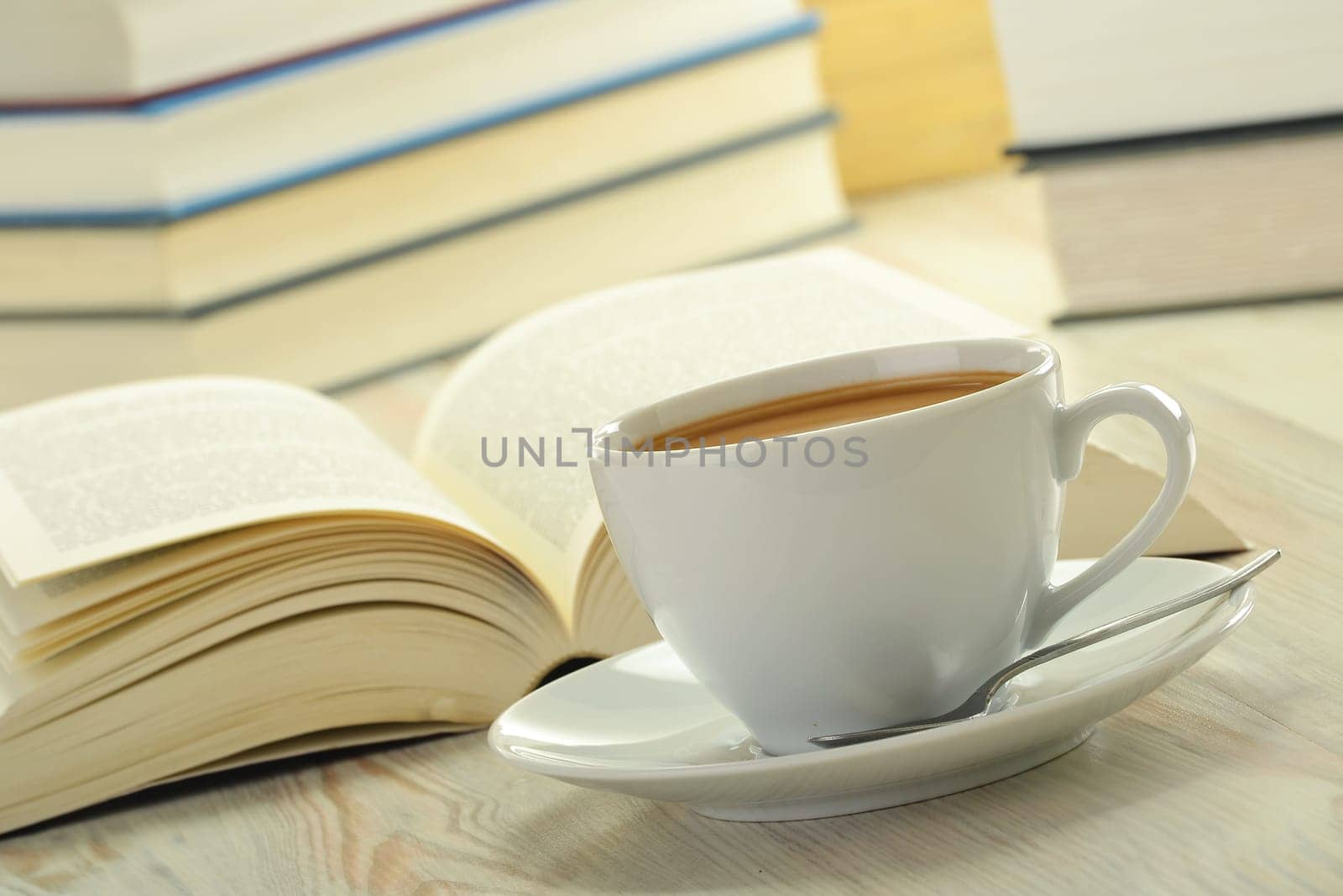 Composition with books and cup of coffee on the table