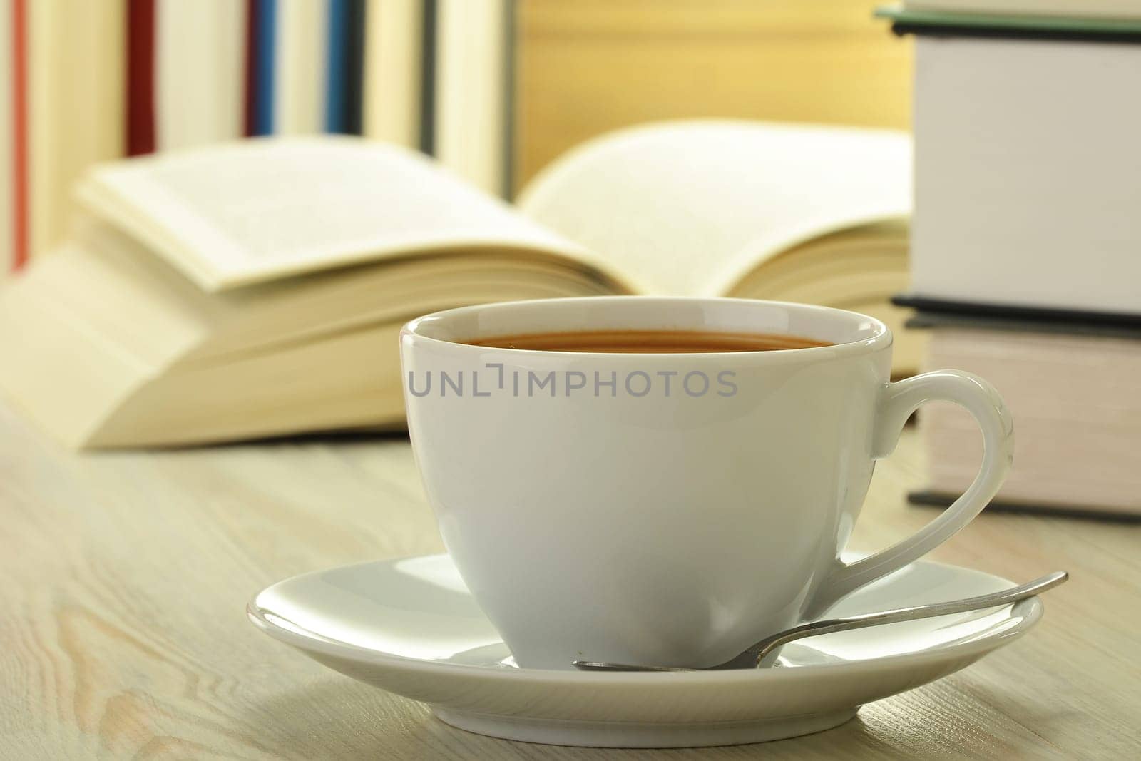 Composition with books and cup of coffee on the table