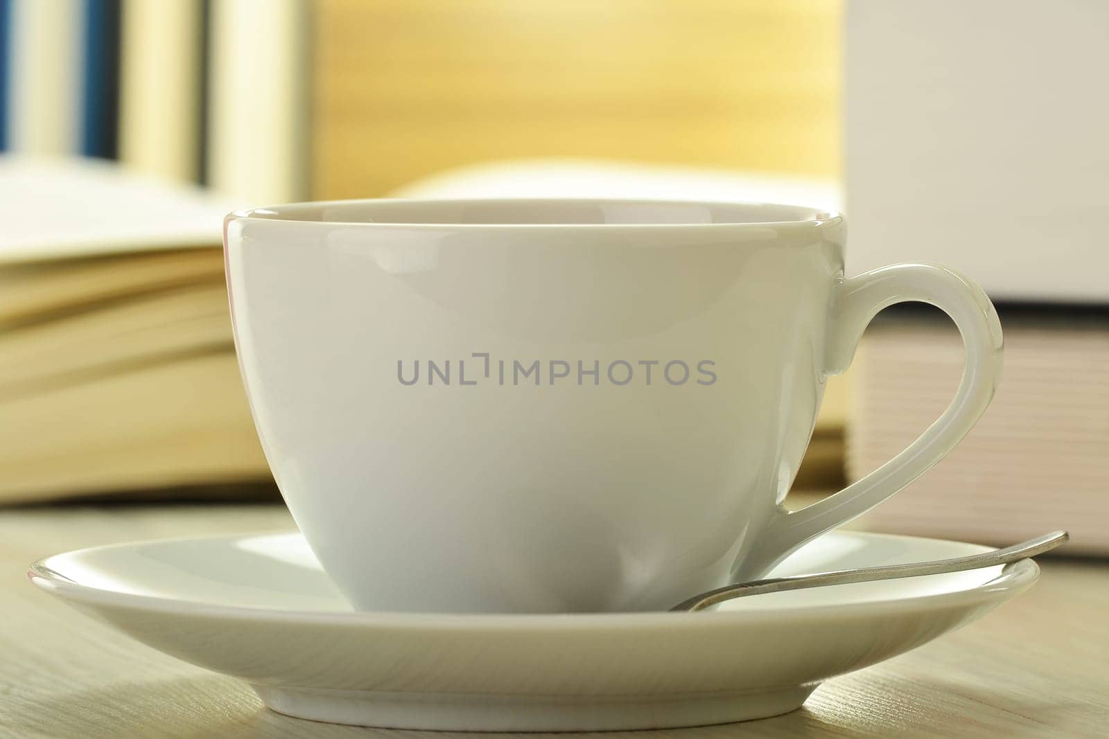 Composition with books and cup of coffee on the table