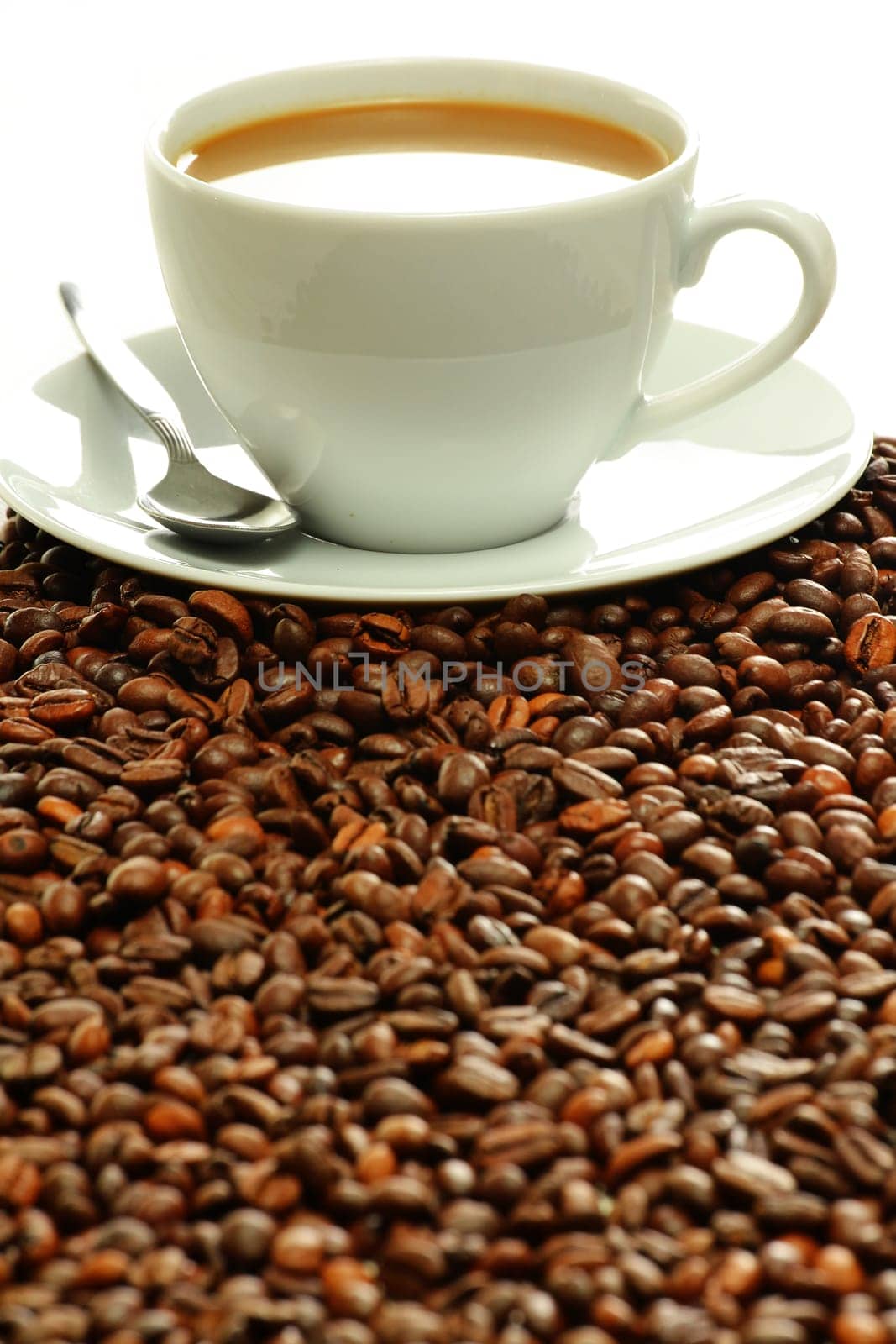 Composition with cup and coffee beans