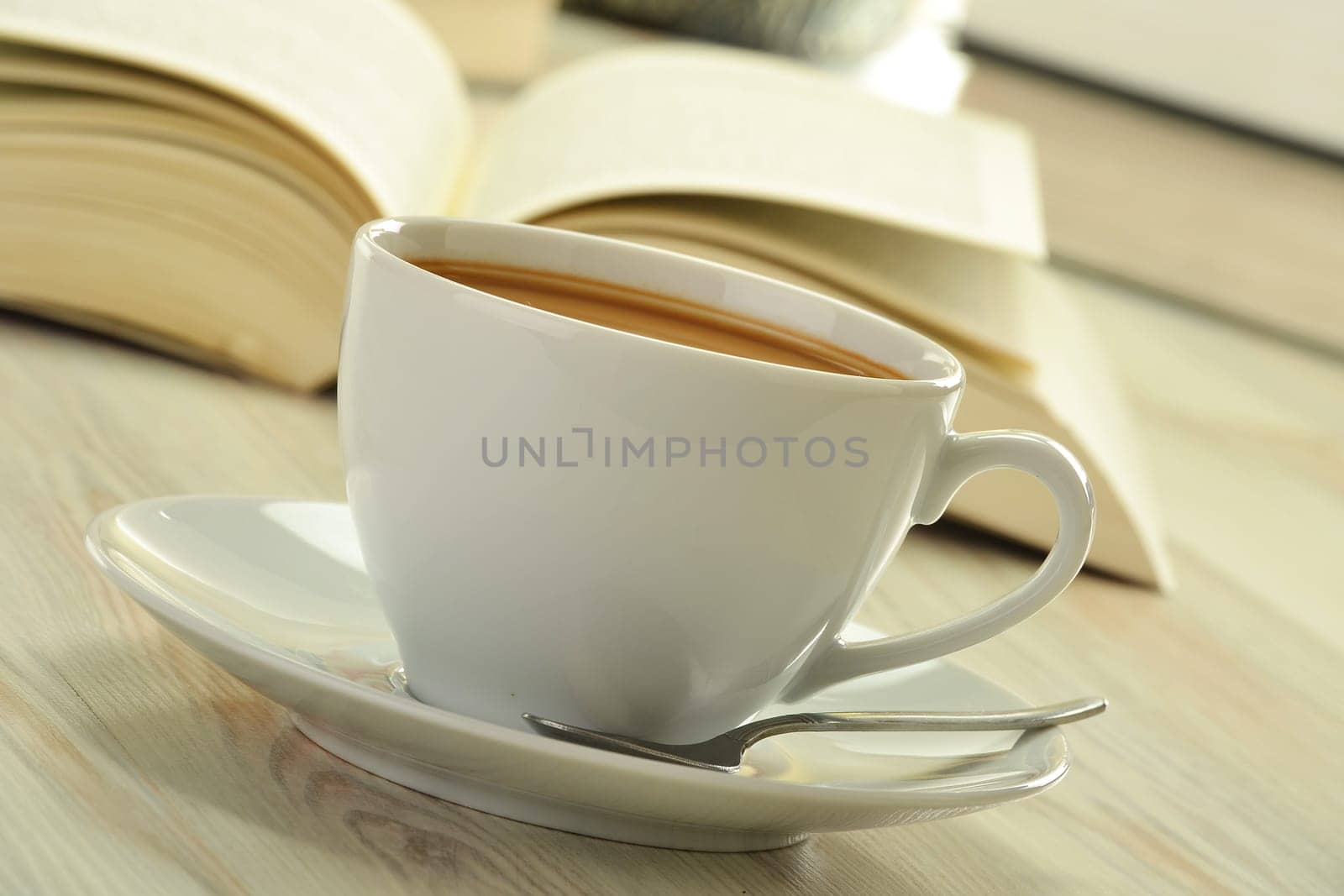 Composition with books and cup of coffee on the table