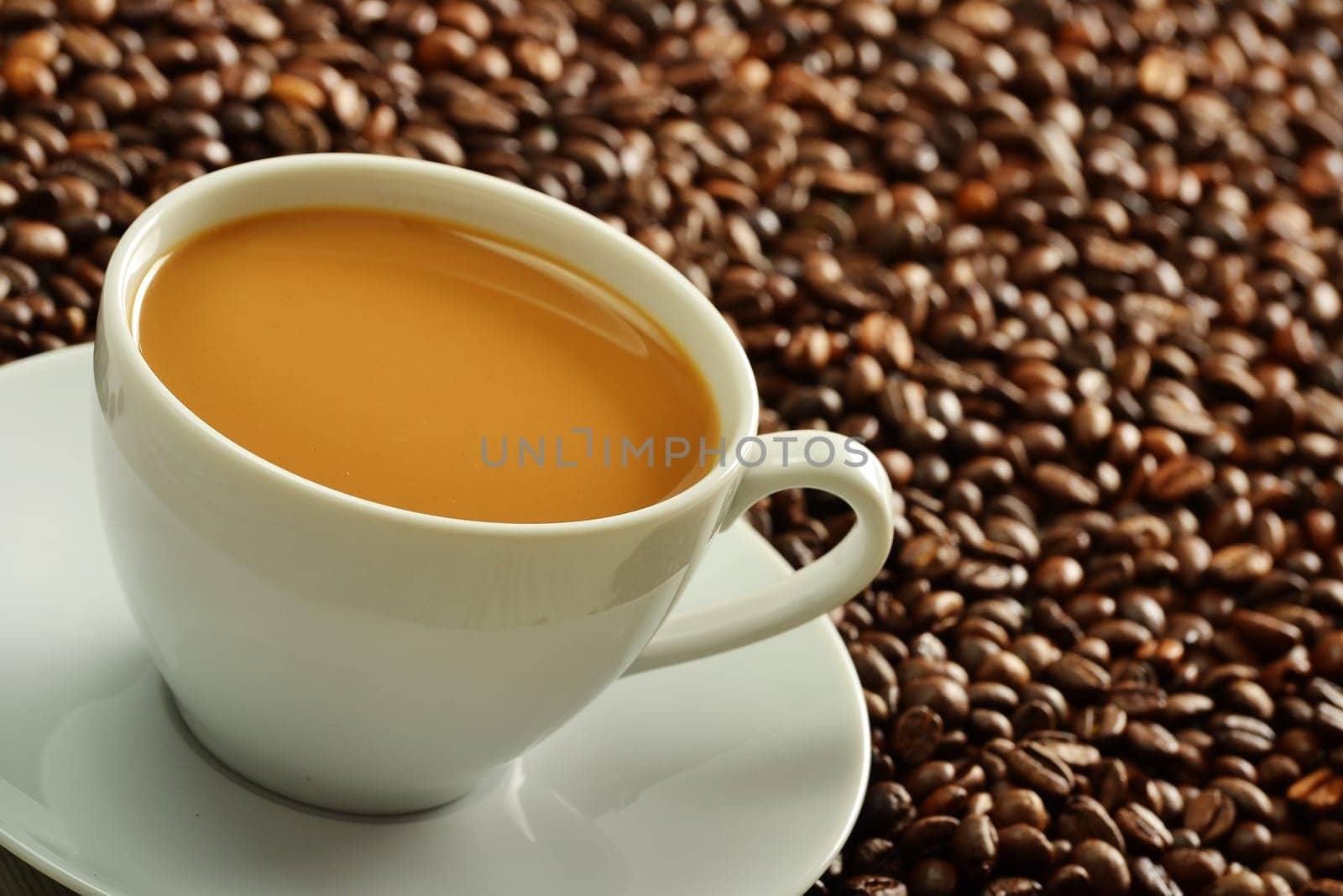 Composition with cup and coffee beans