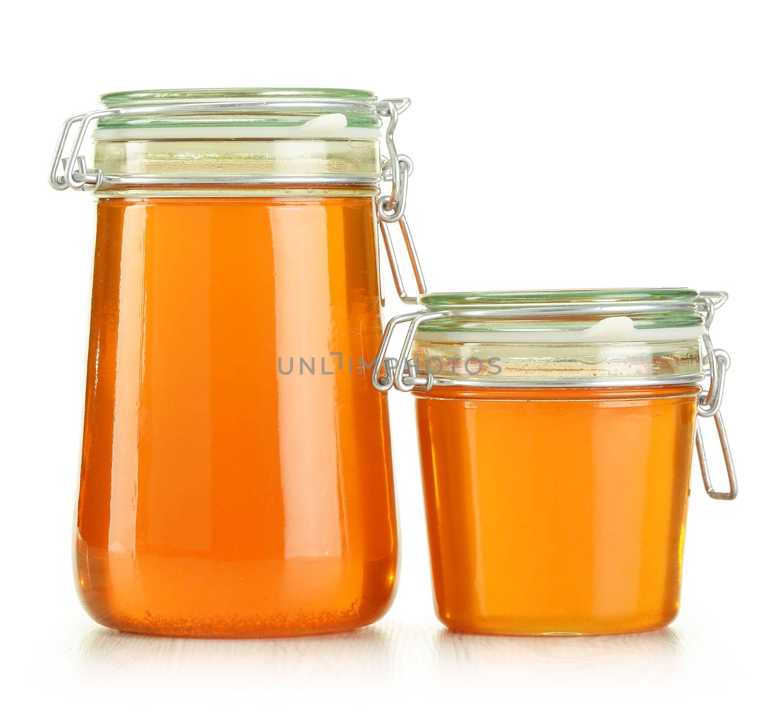 Jars of honey isolated on white