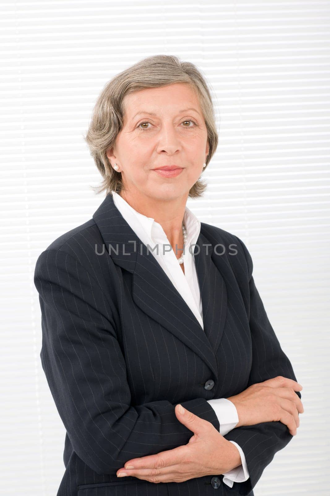 Successful senior businesswoman professional portrait watch camera