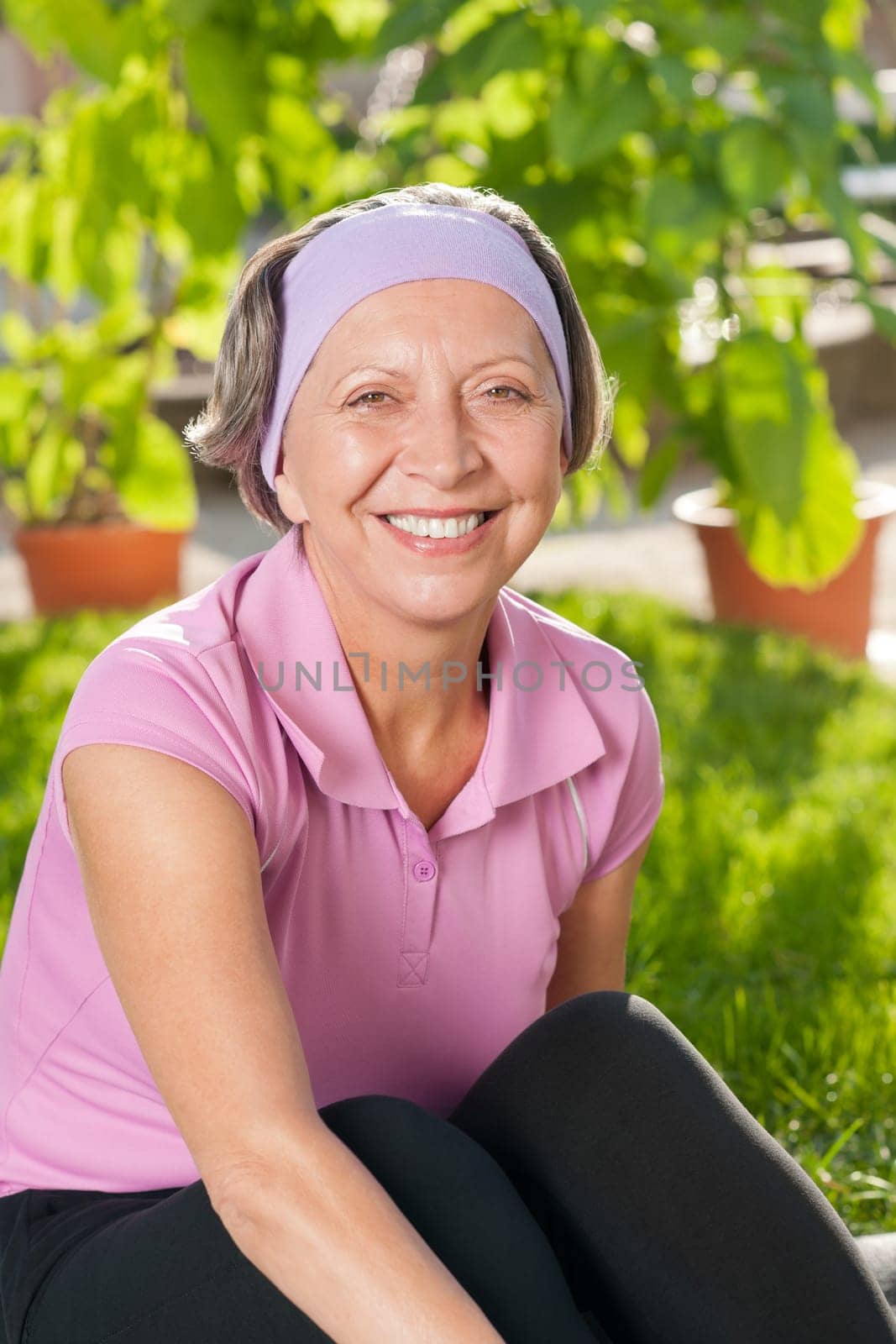 Senior sportive woman smiling outside portrait sunny day