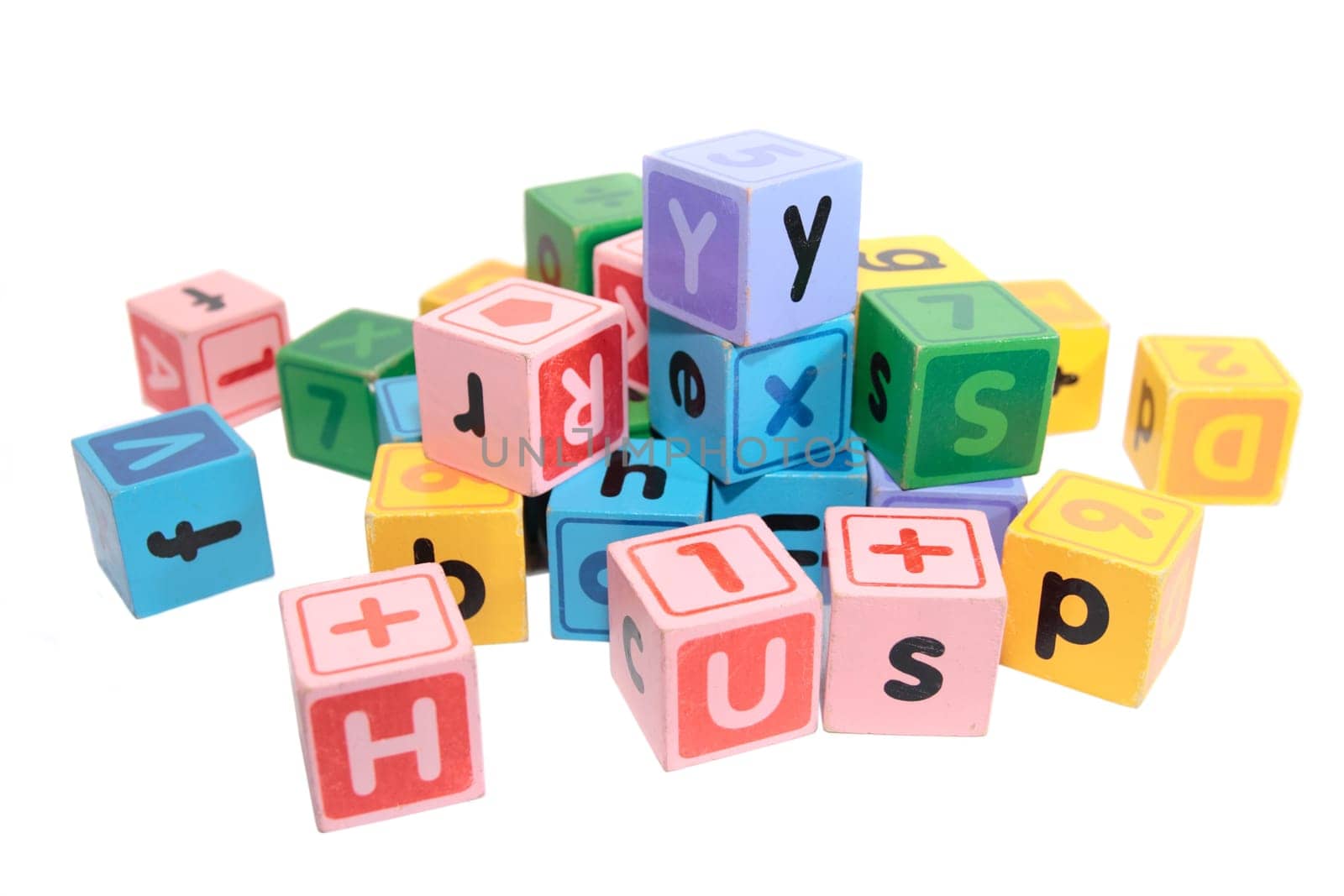 assorted childrens toy letter building blocks against a white background