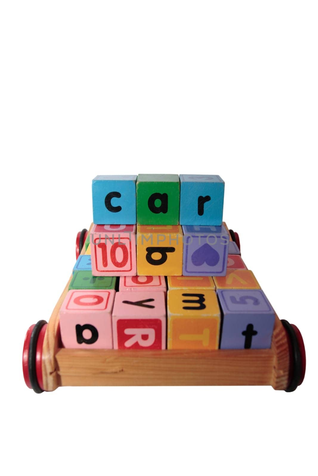 childrens toy letter building blocks all together in a toy cart isolated on white background
