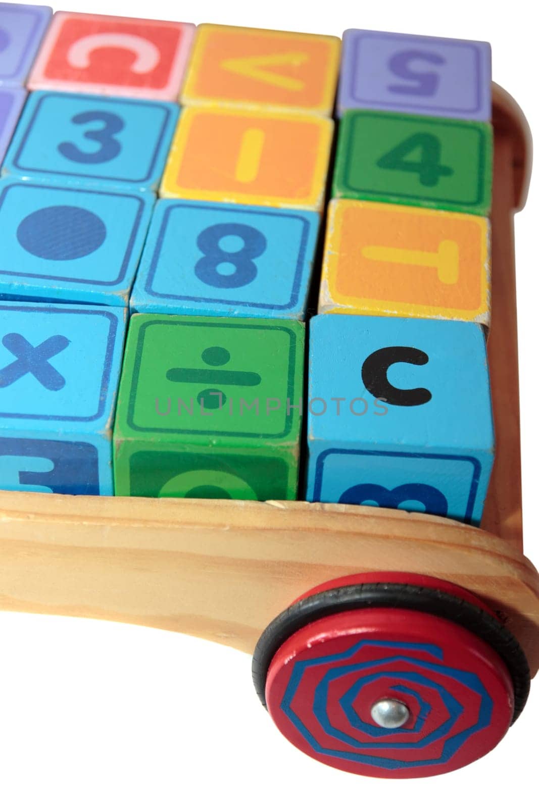 childrens toy letter building blocks all together in a toy cart isolated on white background
