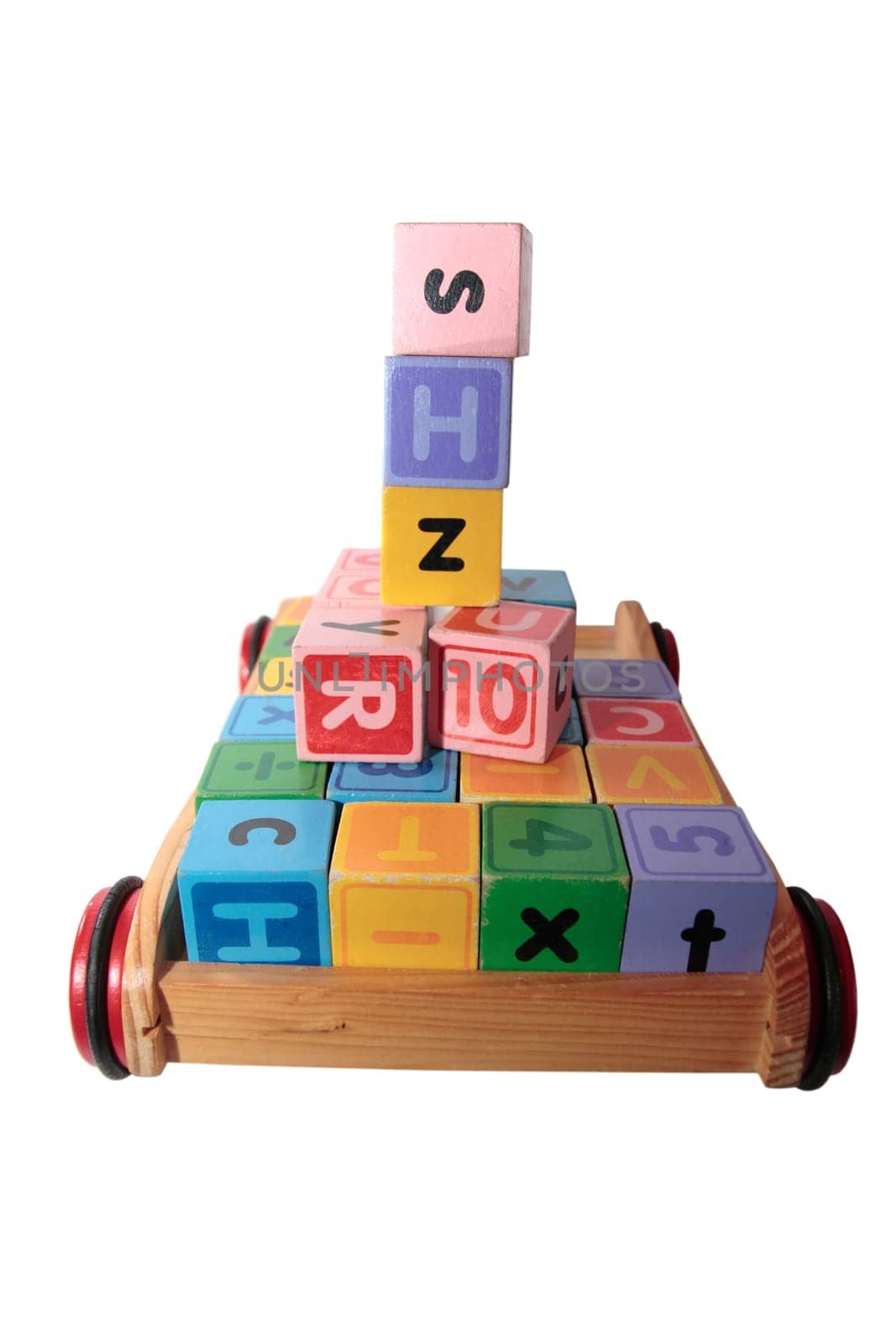 childrens toy letter building blocks all together in a toy cart isolated on white background