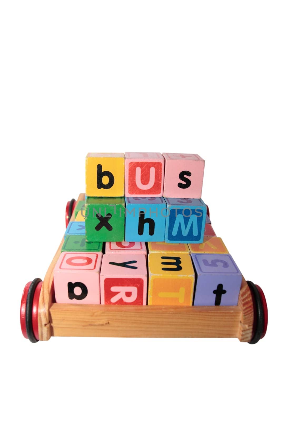 childrens toy letter building blocks all together in a toy cart isolated on white background