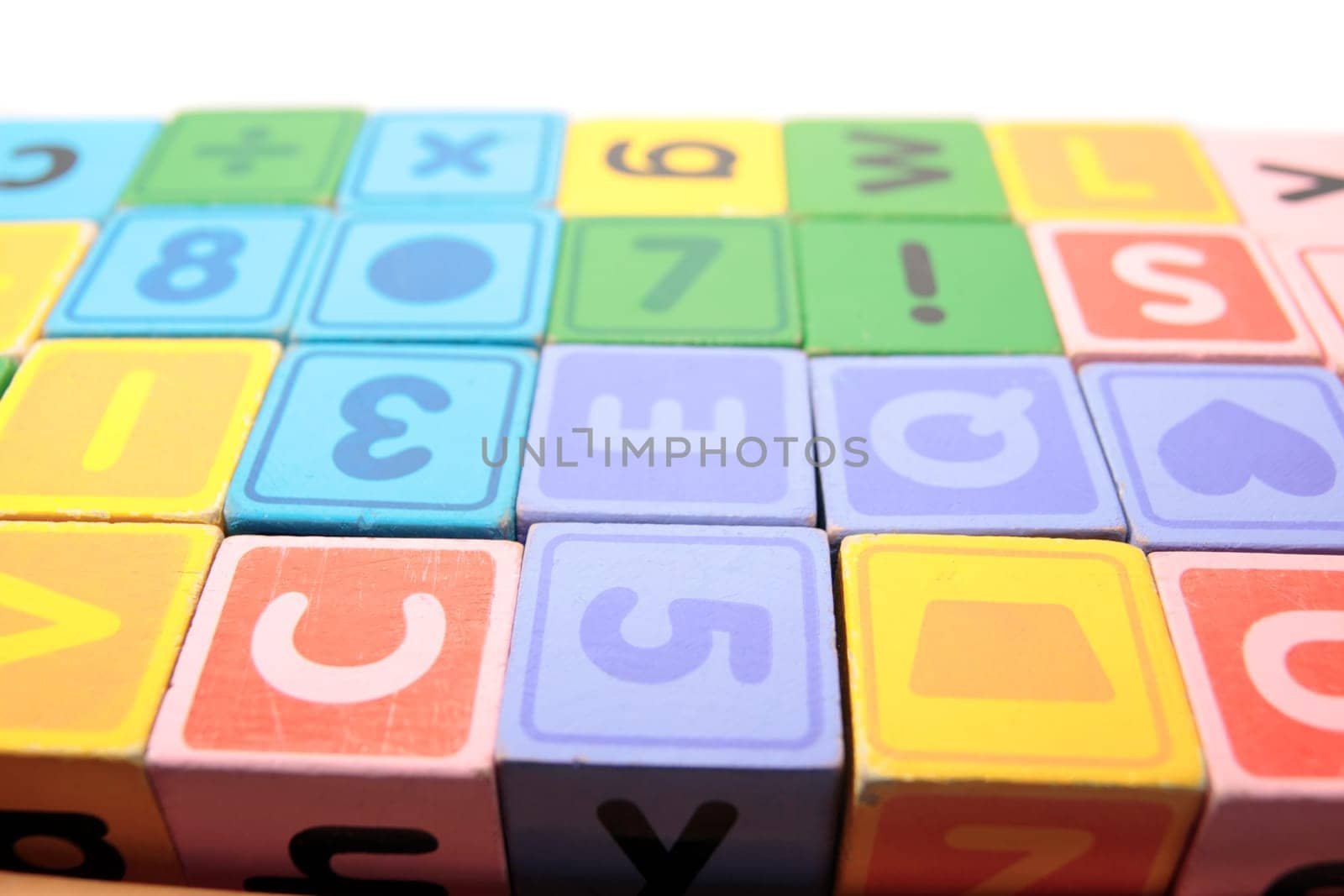 childrens toy letter building blocks against a white background
