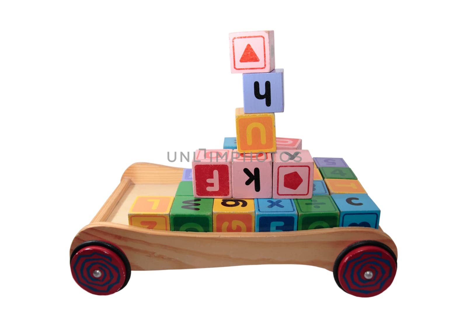 childrens toy letter building blocks all together in a toy cart isolated on white background