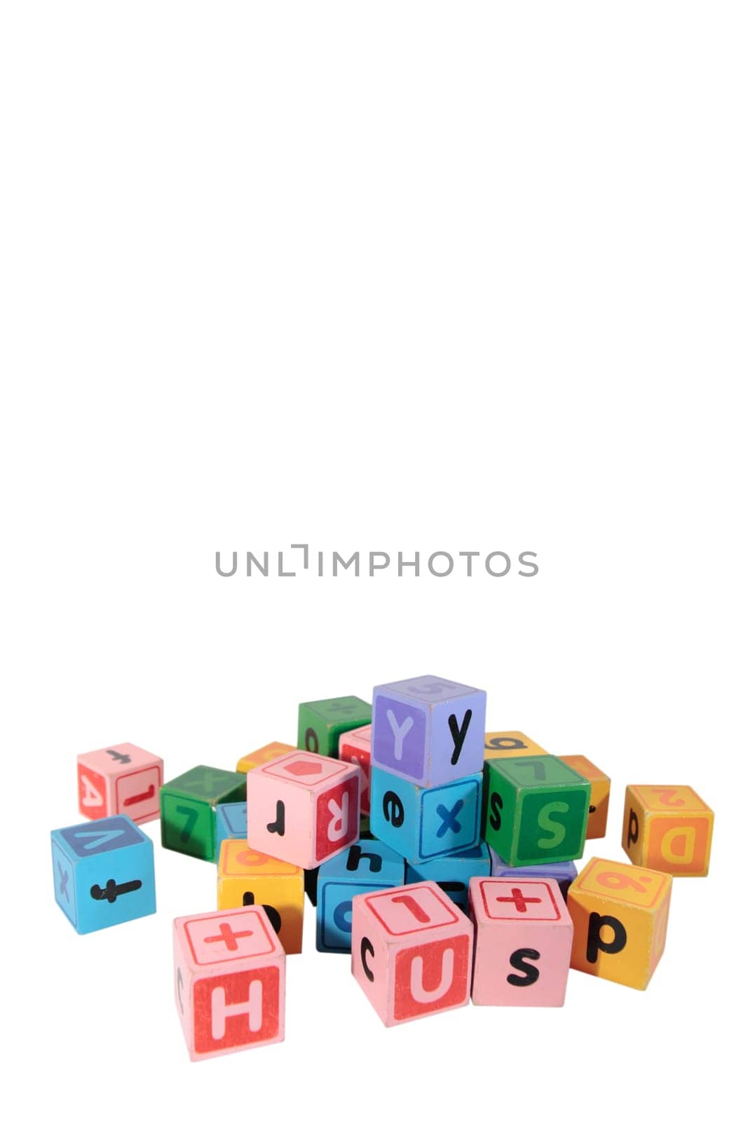 assorted childrens toy letter building blocks against a white background with copy space