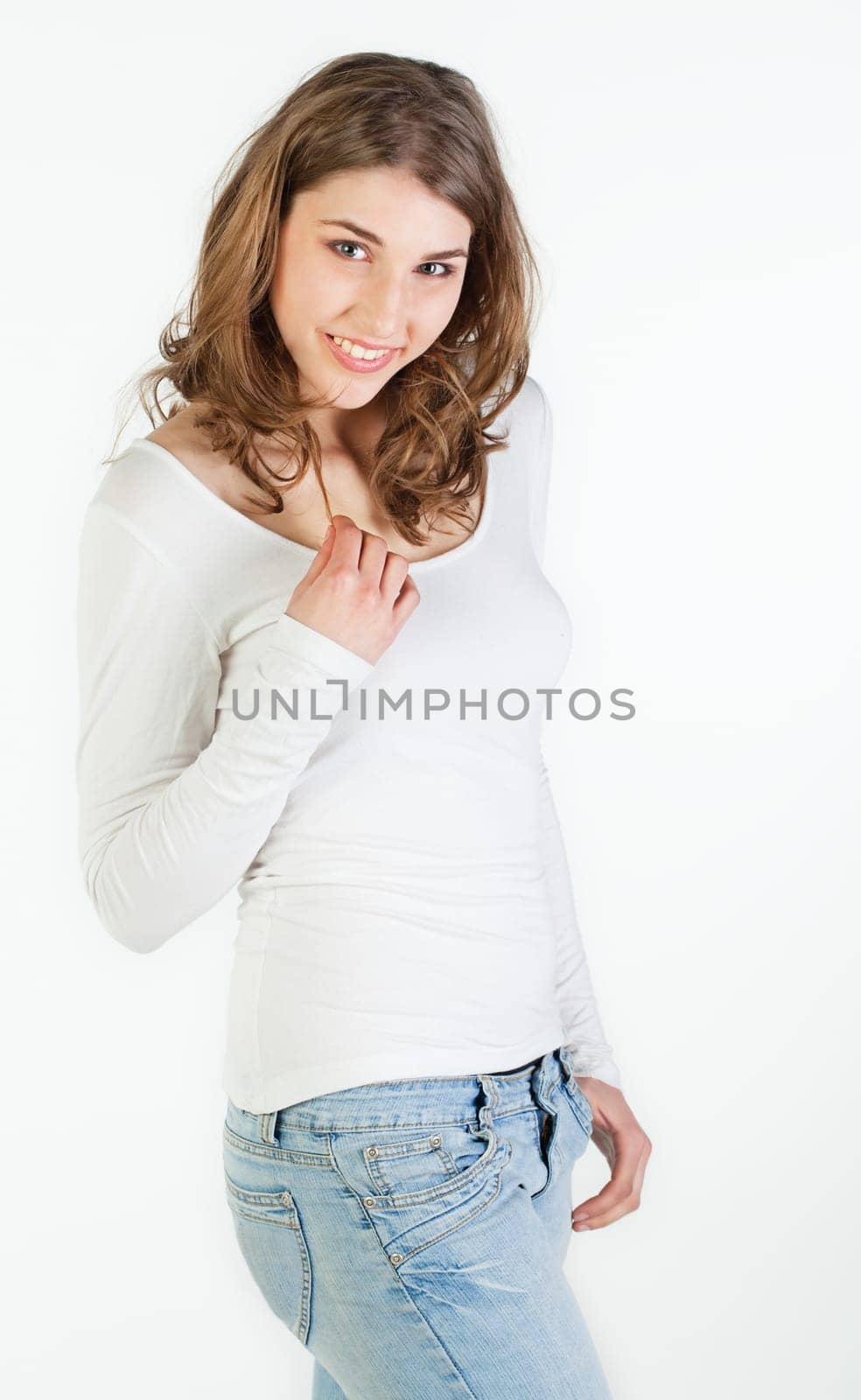 Portrait of smiling pretty teenager girl against white background