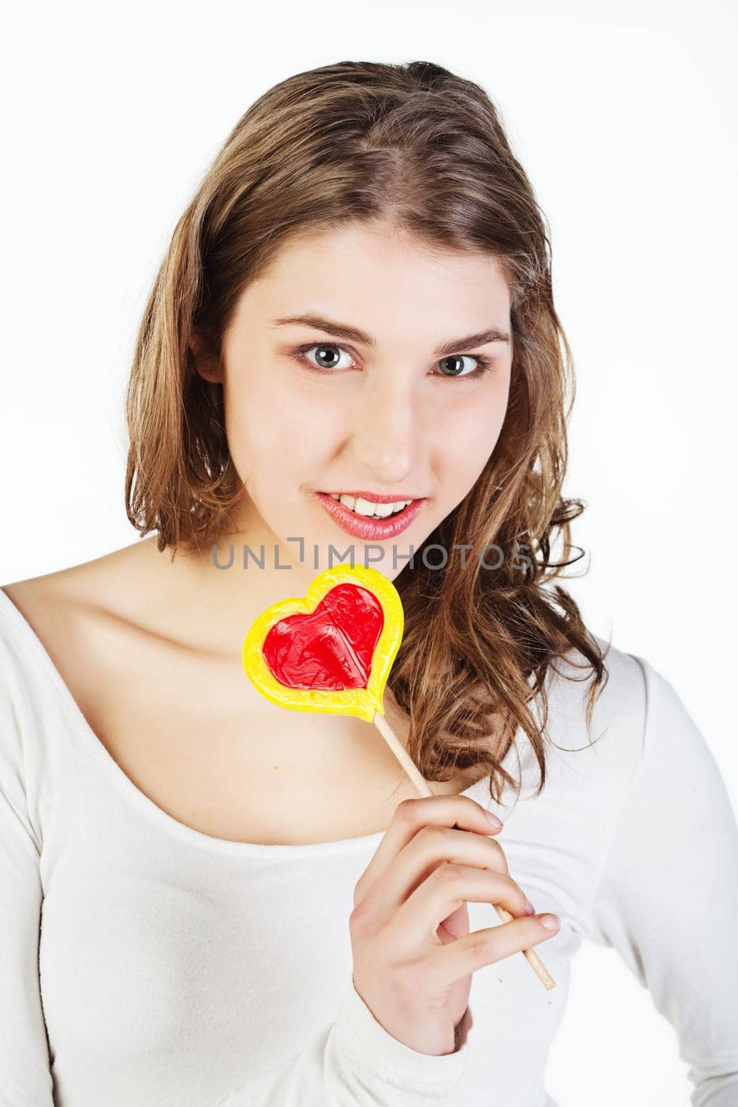 Portrait of smiling teenager girl holding colorful lollipop