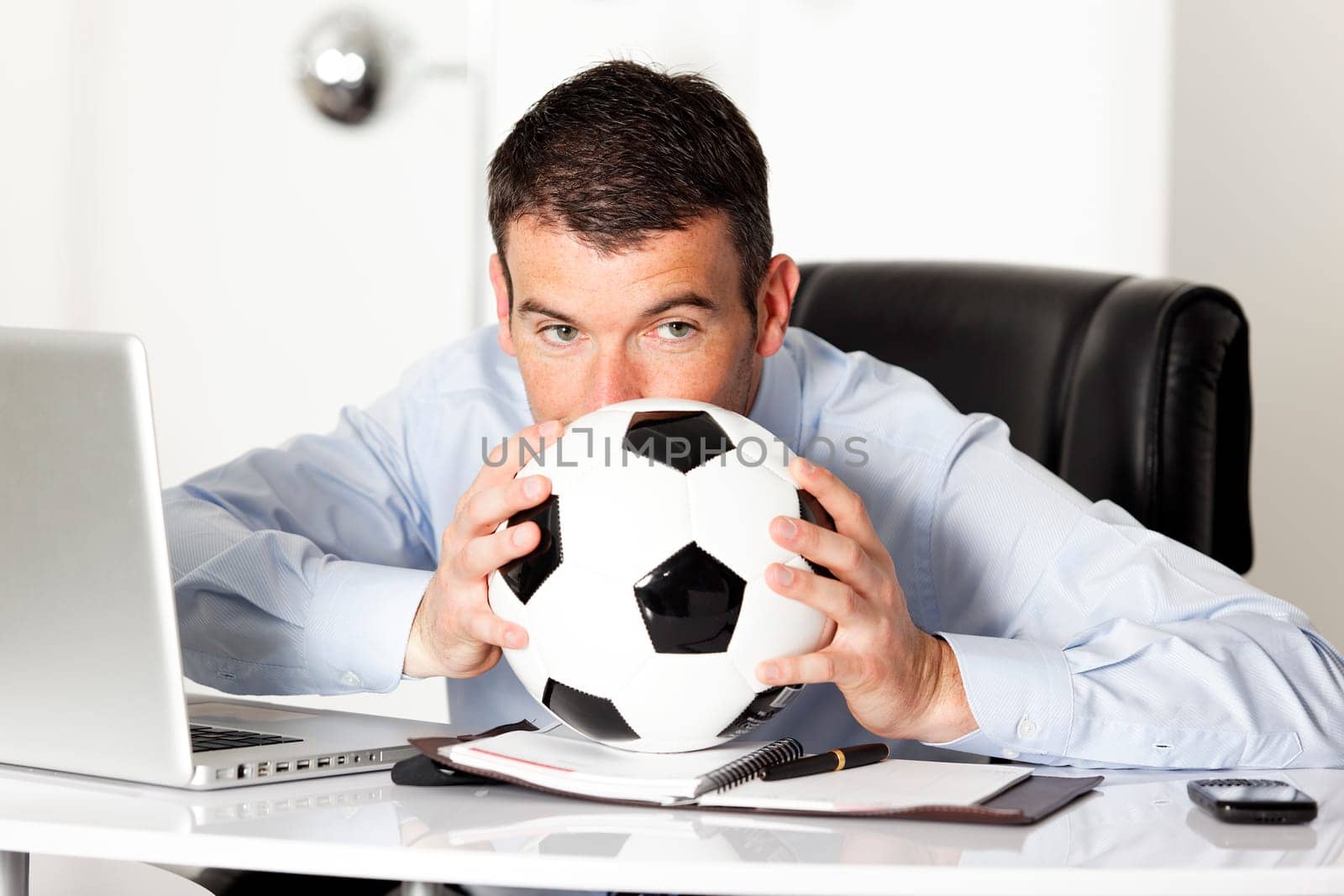 businessman in office with computer and ball