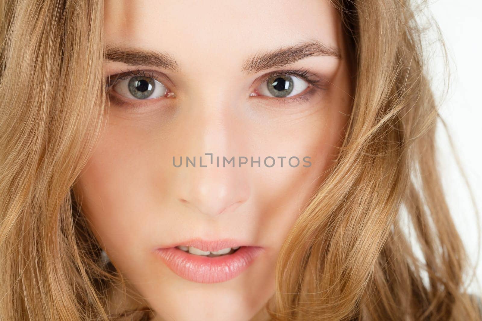Close-up portrait of pretty young woman with long blond hair
