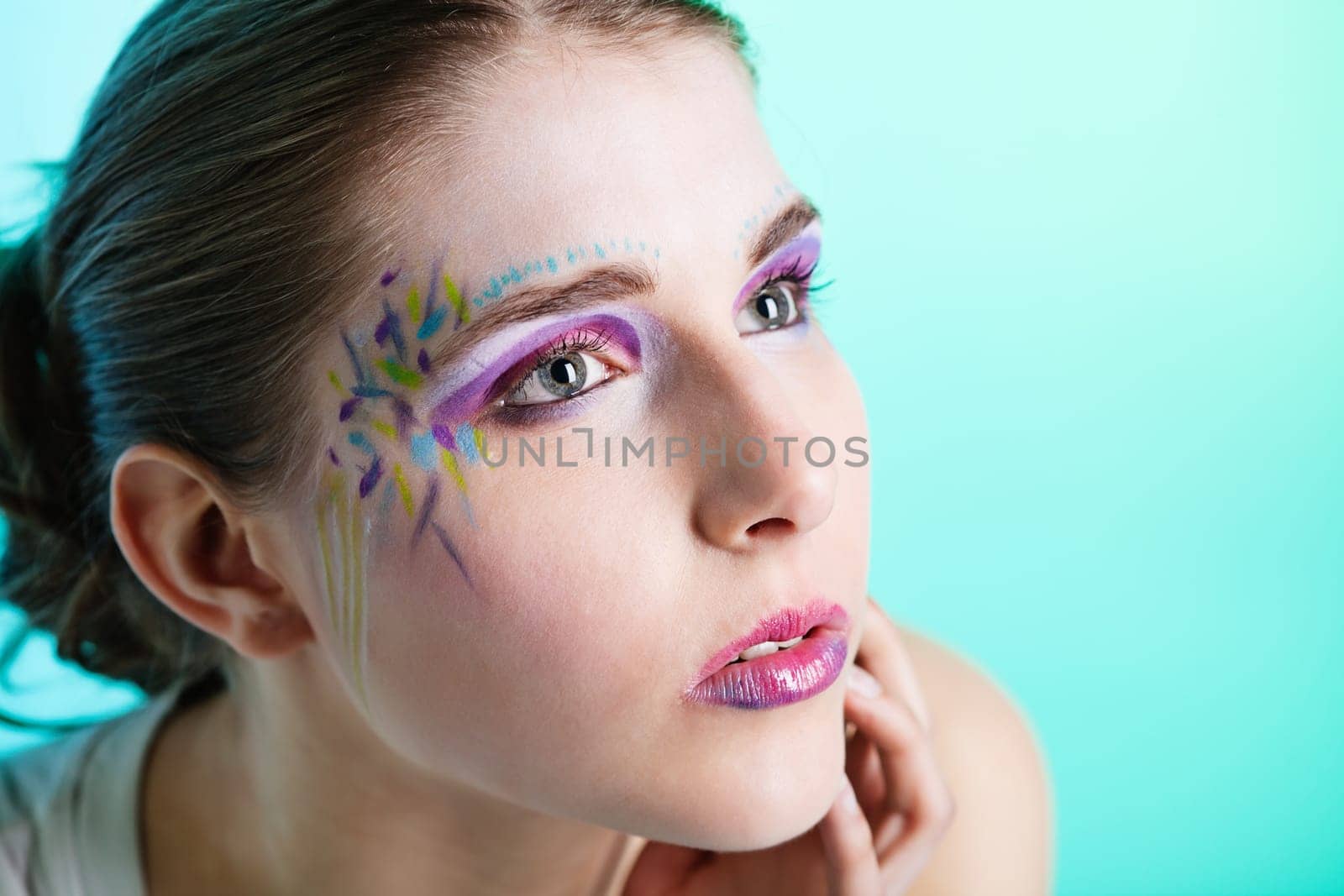 Closeup portrait of a pretty young woman with face art