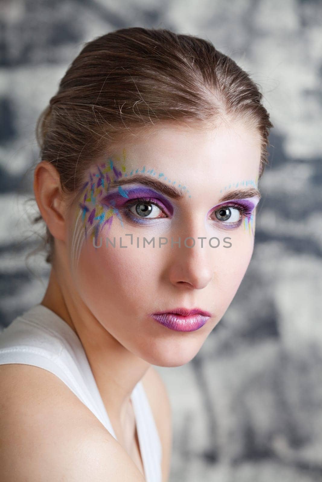 portrait of a pretty young woman with face art