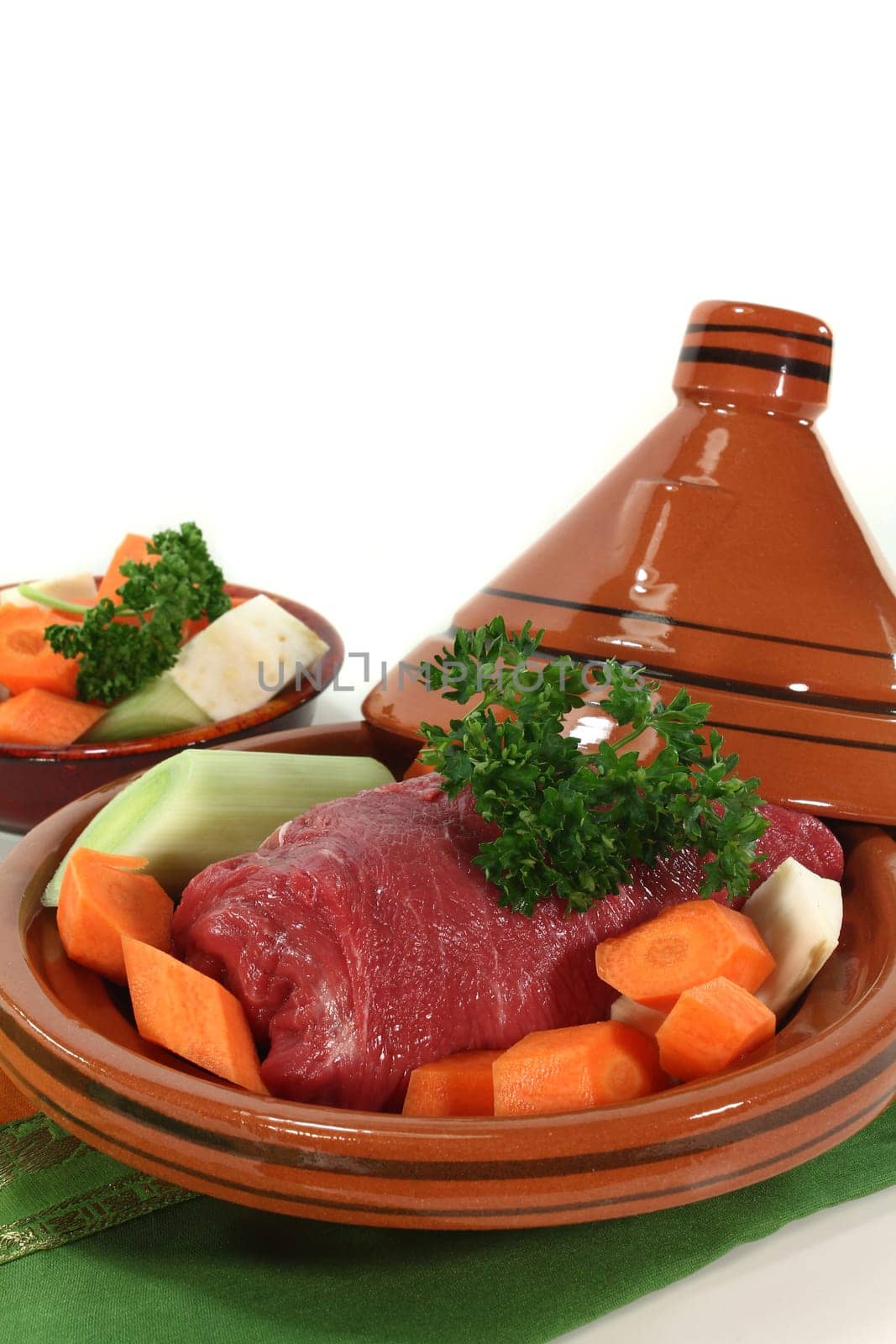 raw roast beef with vegetables in a tagine