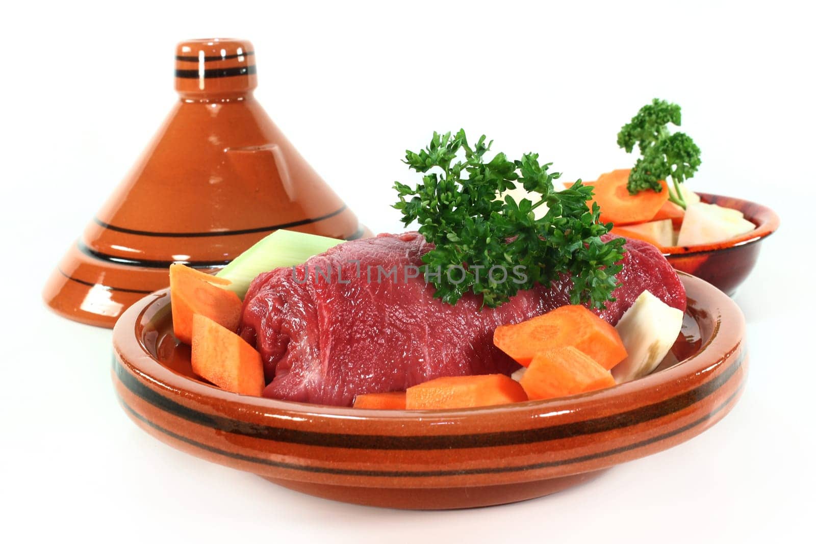 raw roast beef with vegetables in a tagine