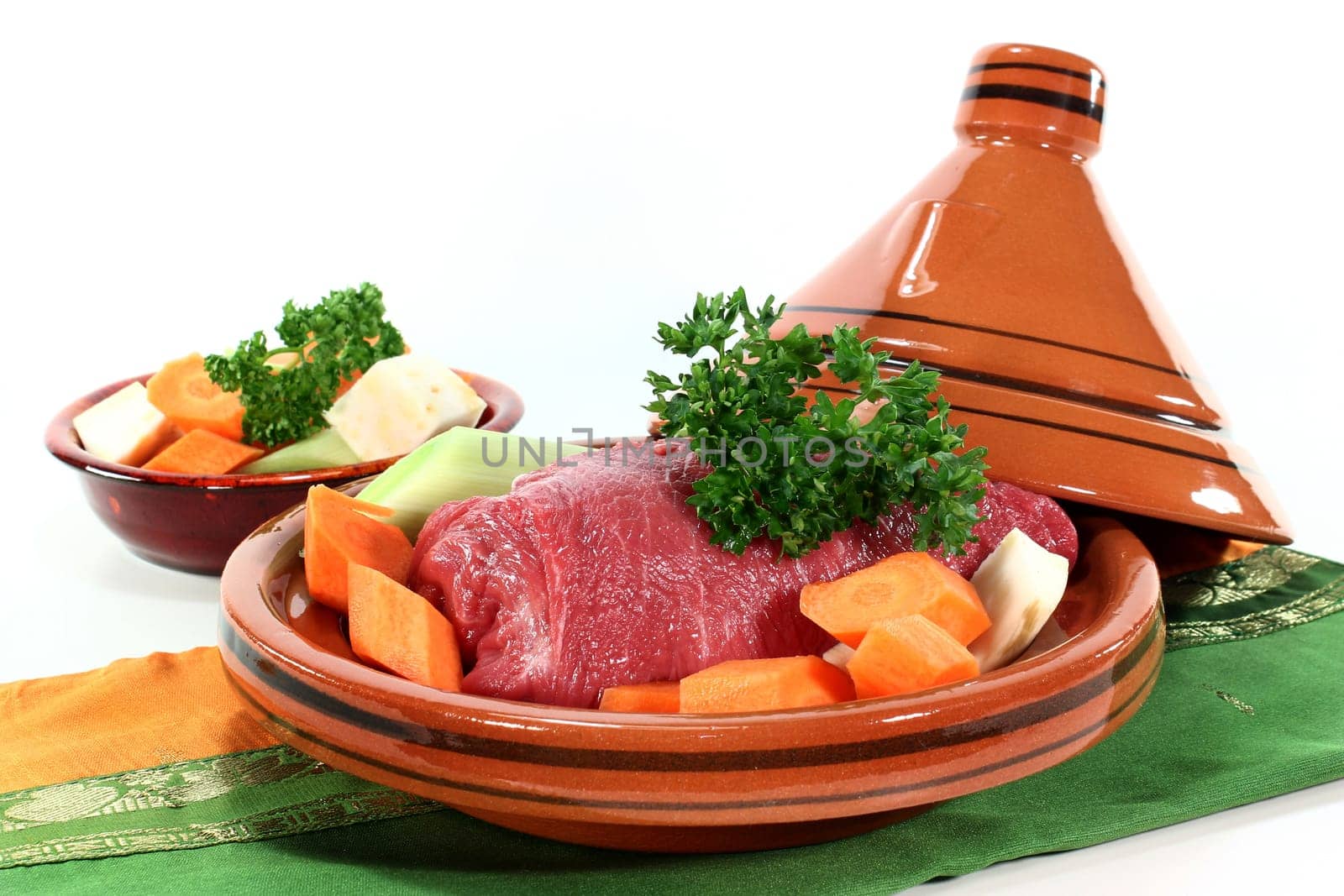 raw roast beef with vegetables in a tagine