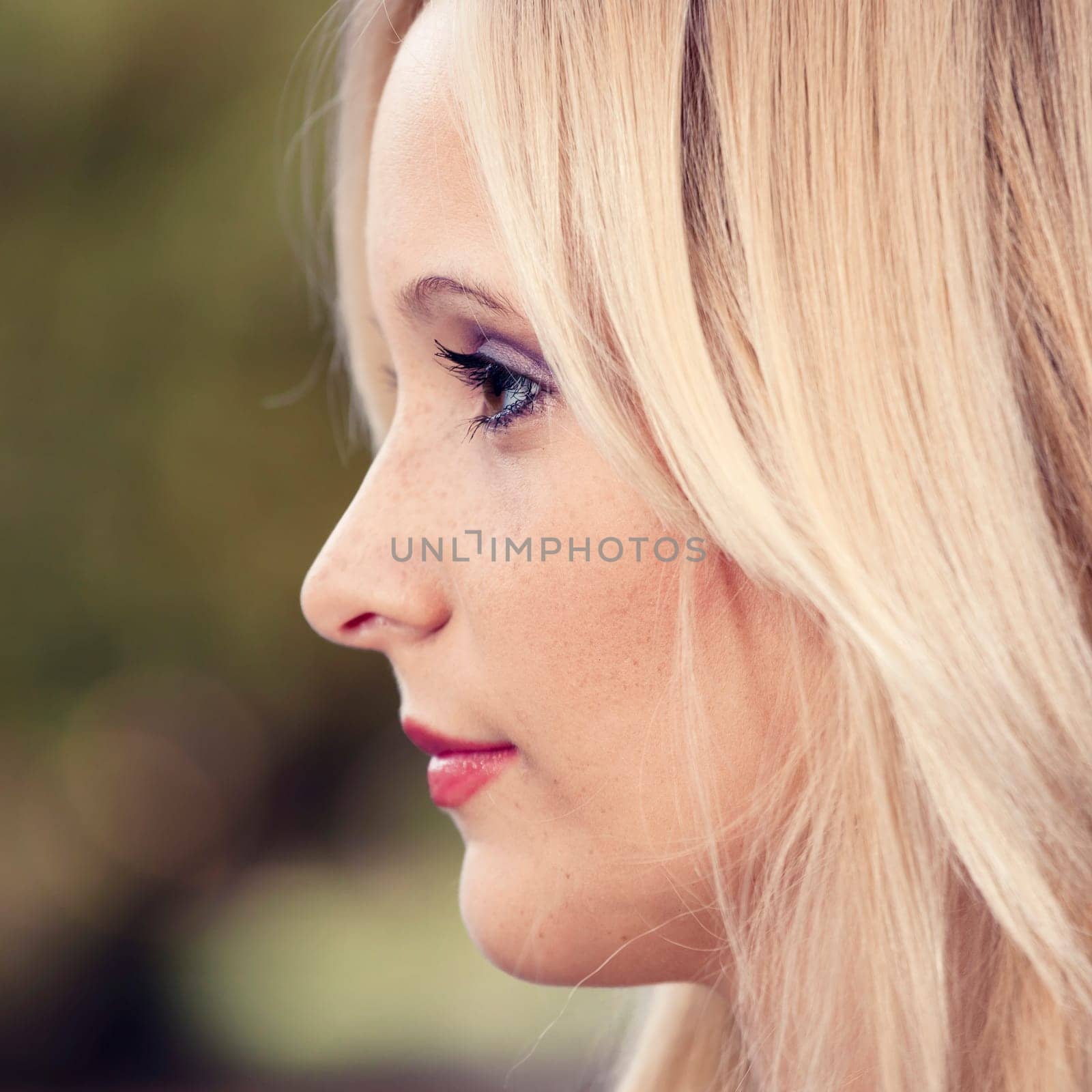 Outdoor portrait of a beautiful young woman in the park