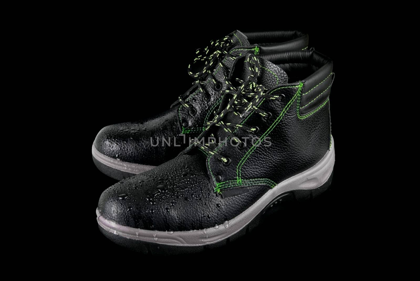 moist modern working boots isolated on a black background