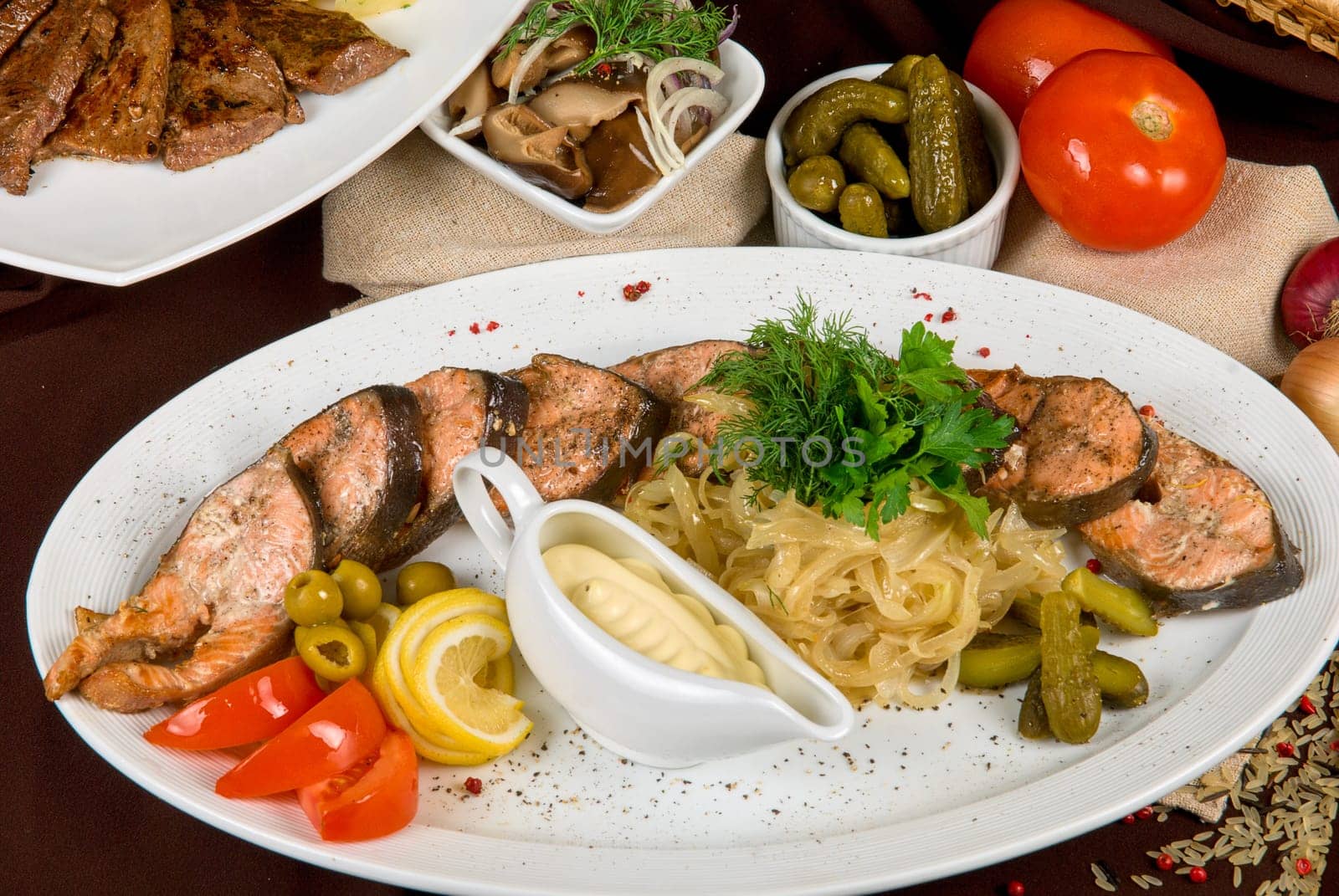 Many food dishes on the table. Fish dish close up.