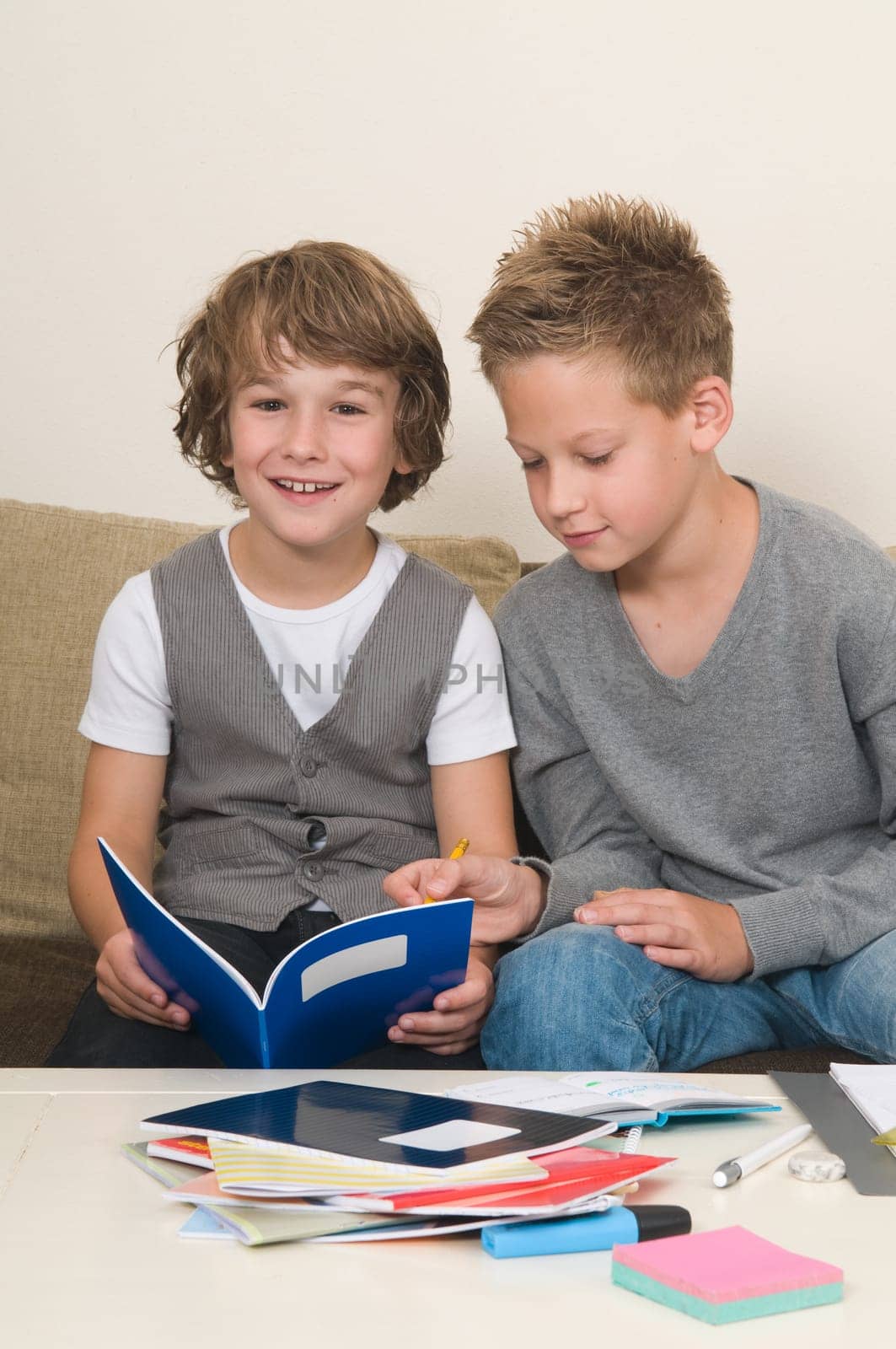 Two friends doing their homework in the livingroom