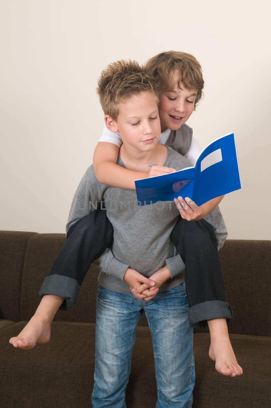 Two friends doing their homework in the livingroom
