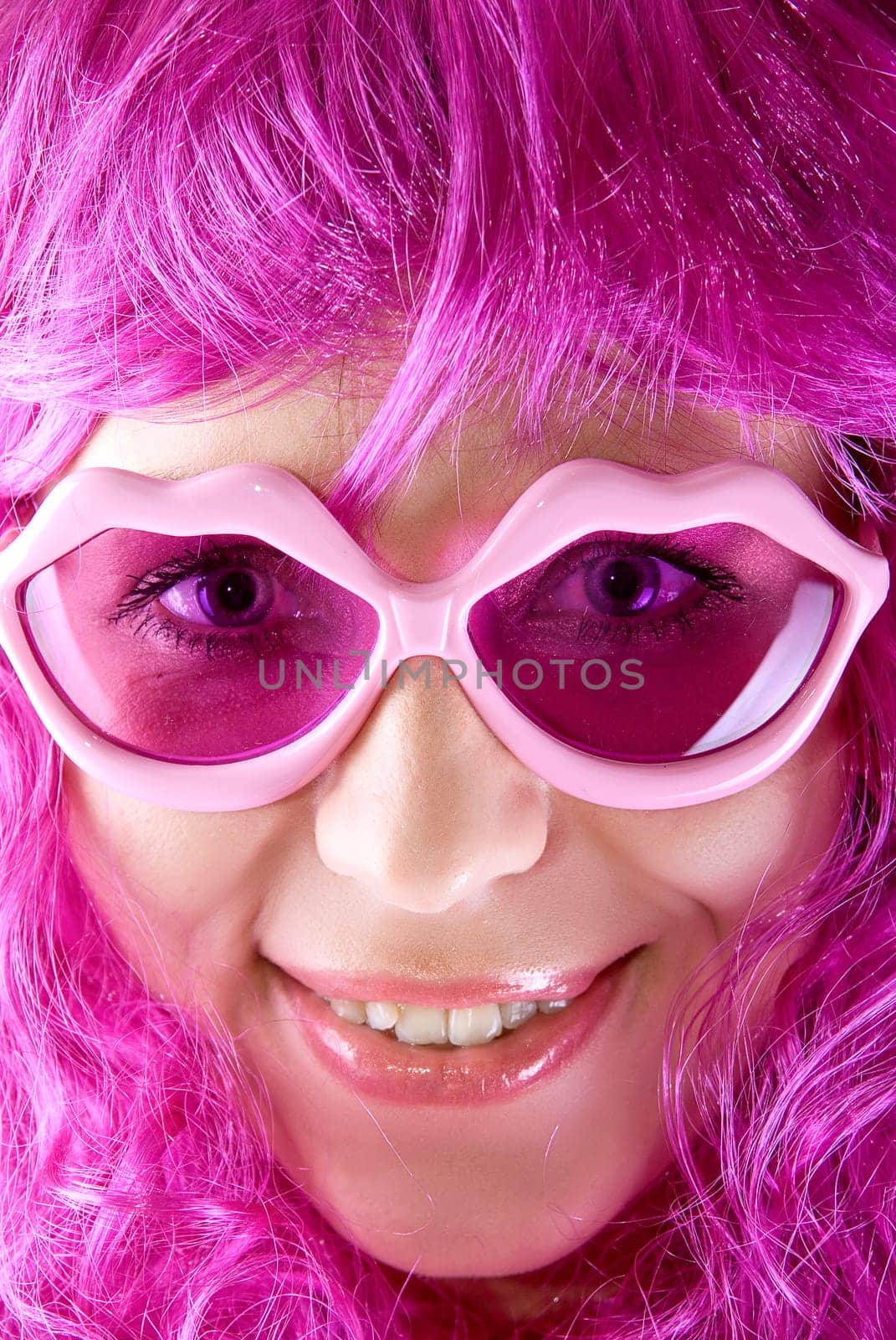 Photo of a pink girl closeup portrait with lips shaped glasses