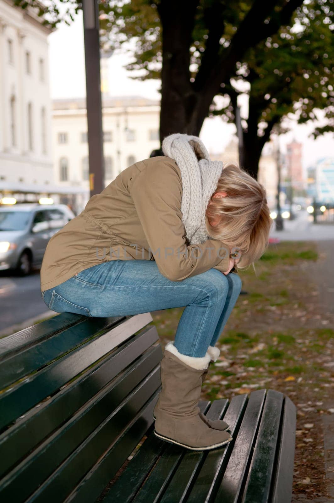 Sad young woman on a bench