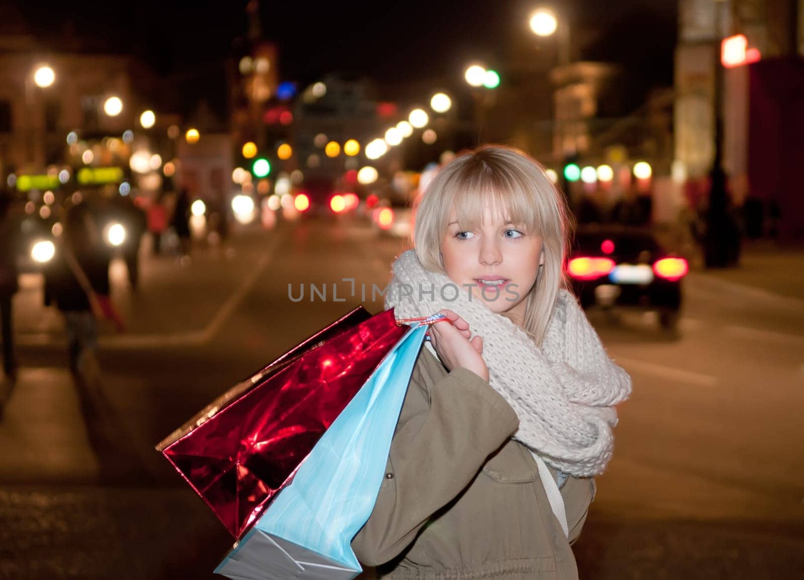 Young woman shopping in the evening big city