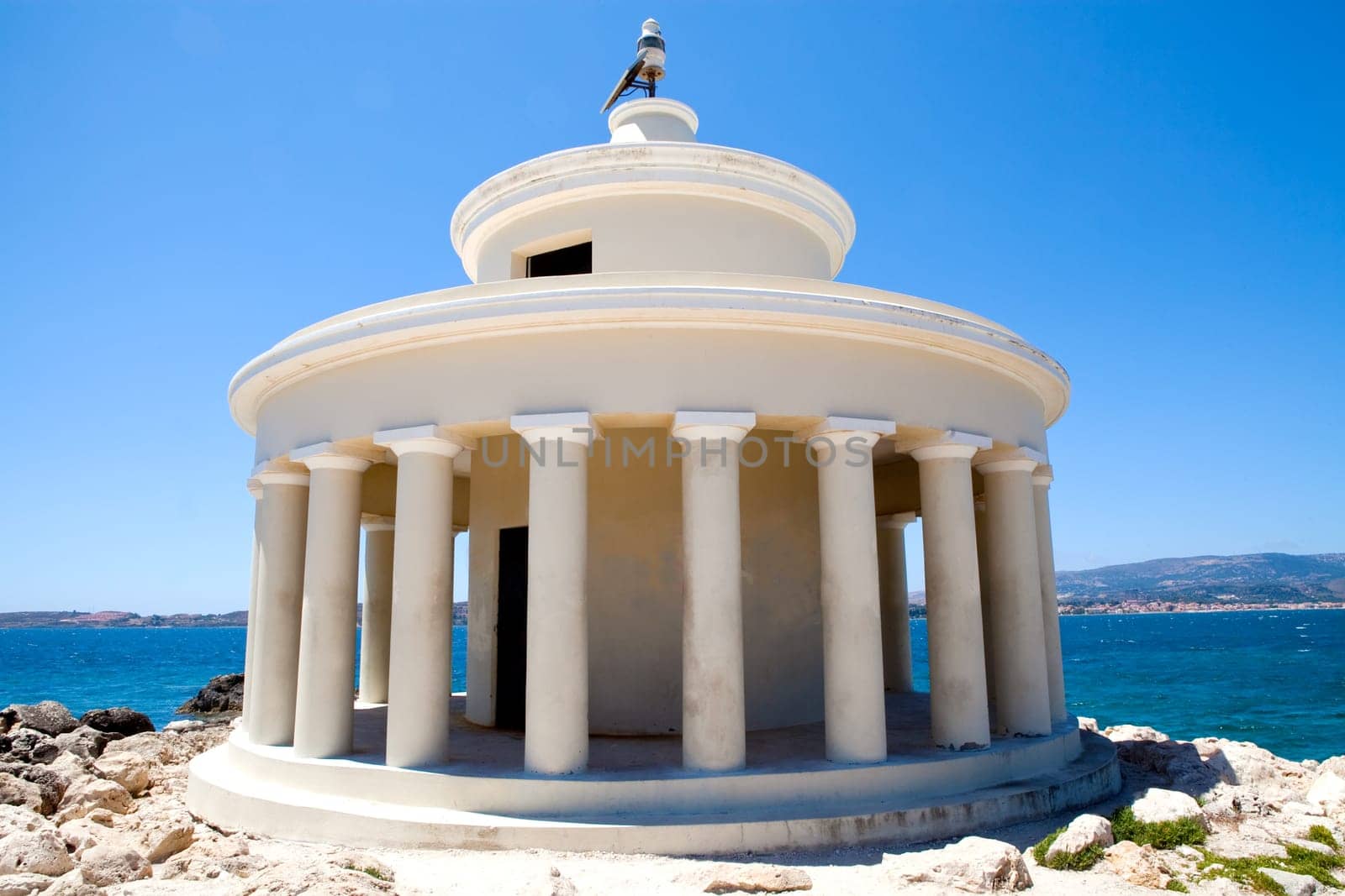 Lighthouse with blue sea in the background in Argostoli, Kefalonia, Greece
