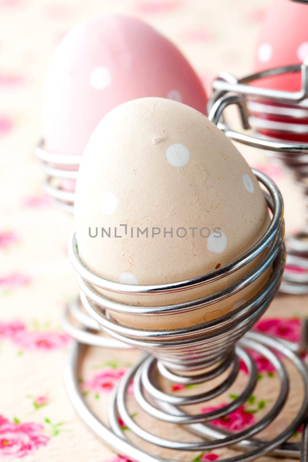 Close-up of pastel colored Easter eggs in metal holders
