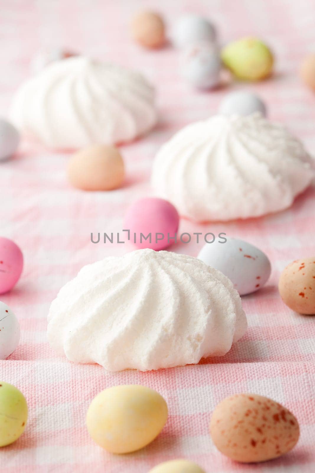 Close-up of pastel colored chocolate Easter egg candy with white meringue