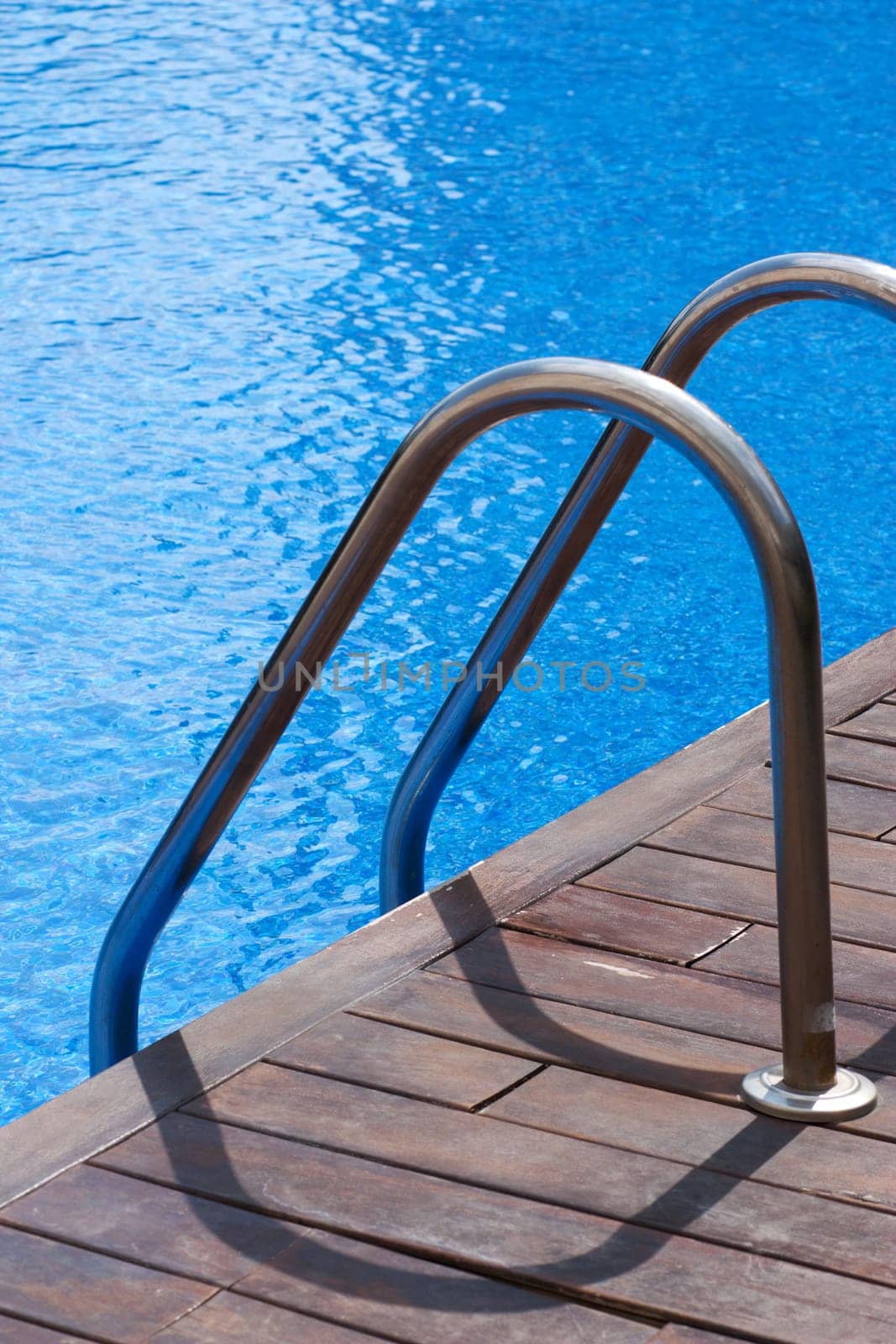 Ladder and handrail on the banks of a swimming pool