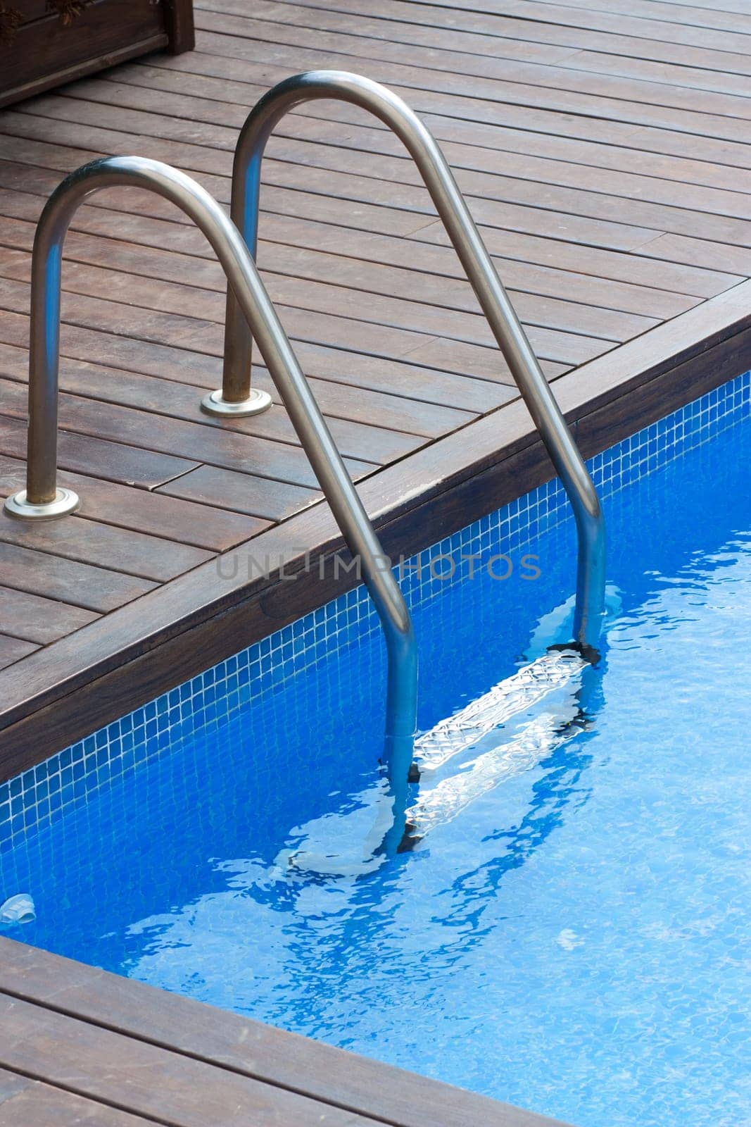 Ladder and handrail on the banks of a swimming pool
