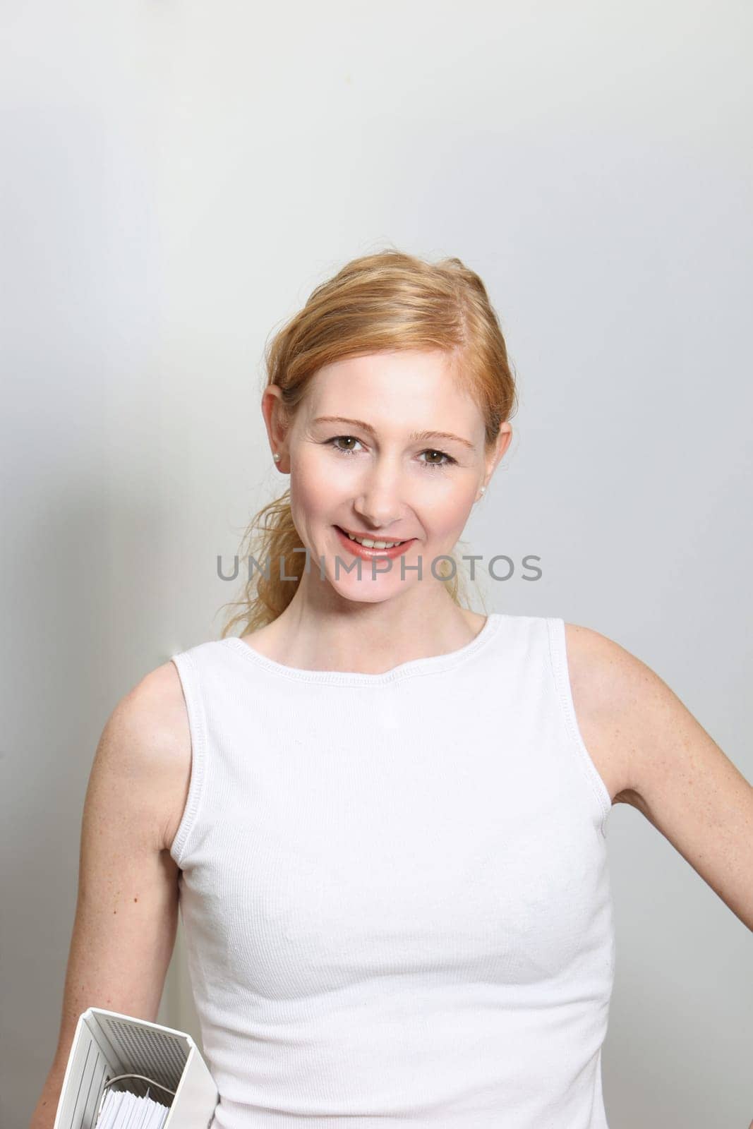 Young,pretty woman with file folder in office - portrait format
