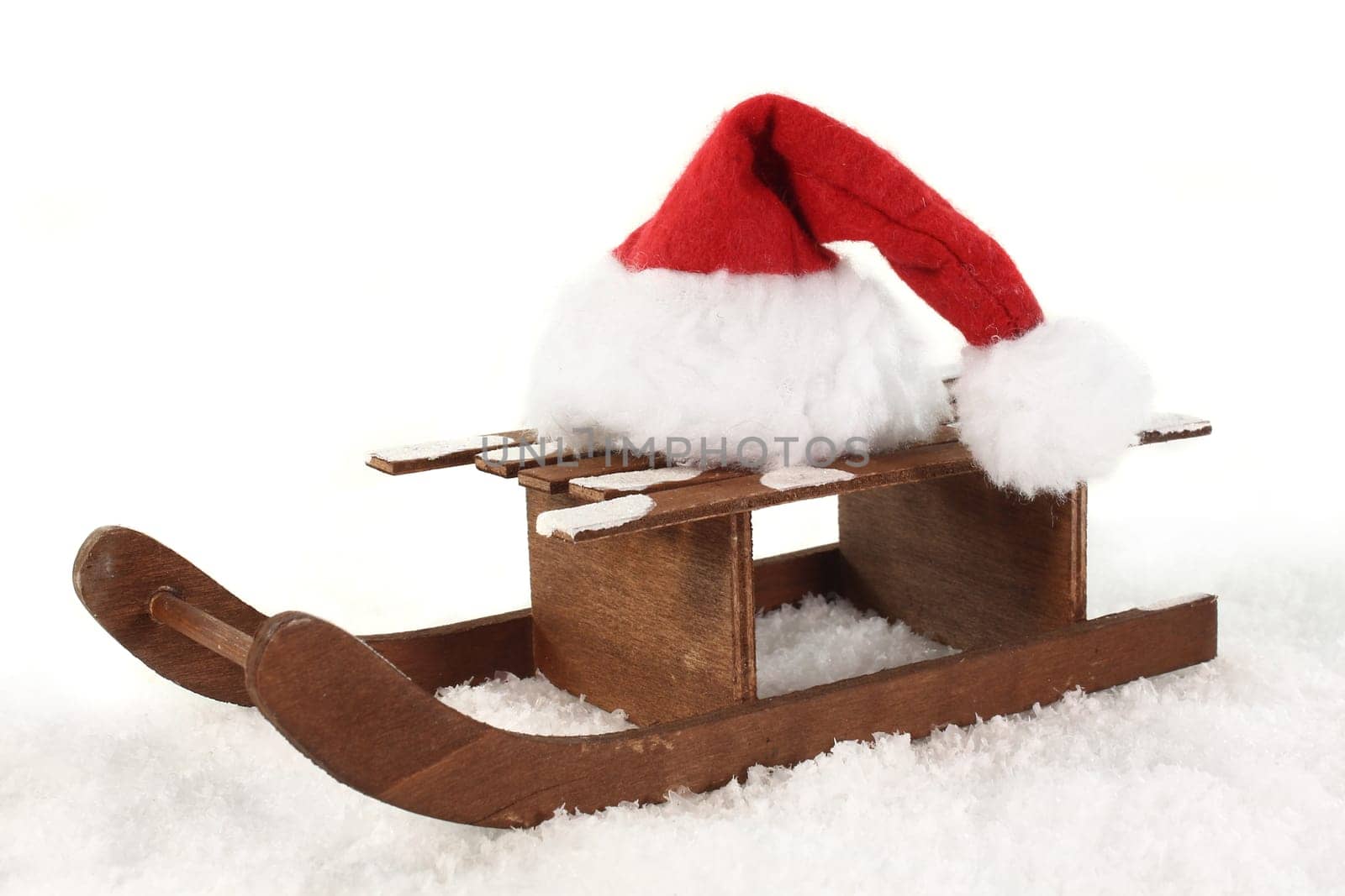 a sleigh with a Santa hat in the snow