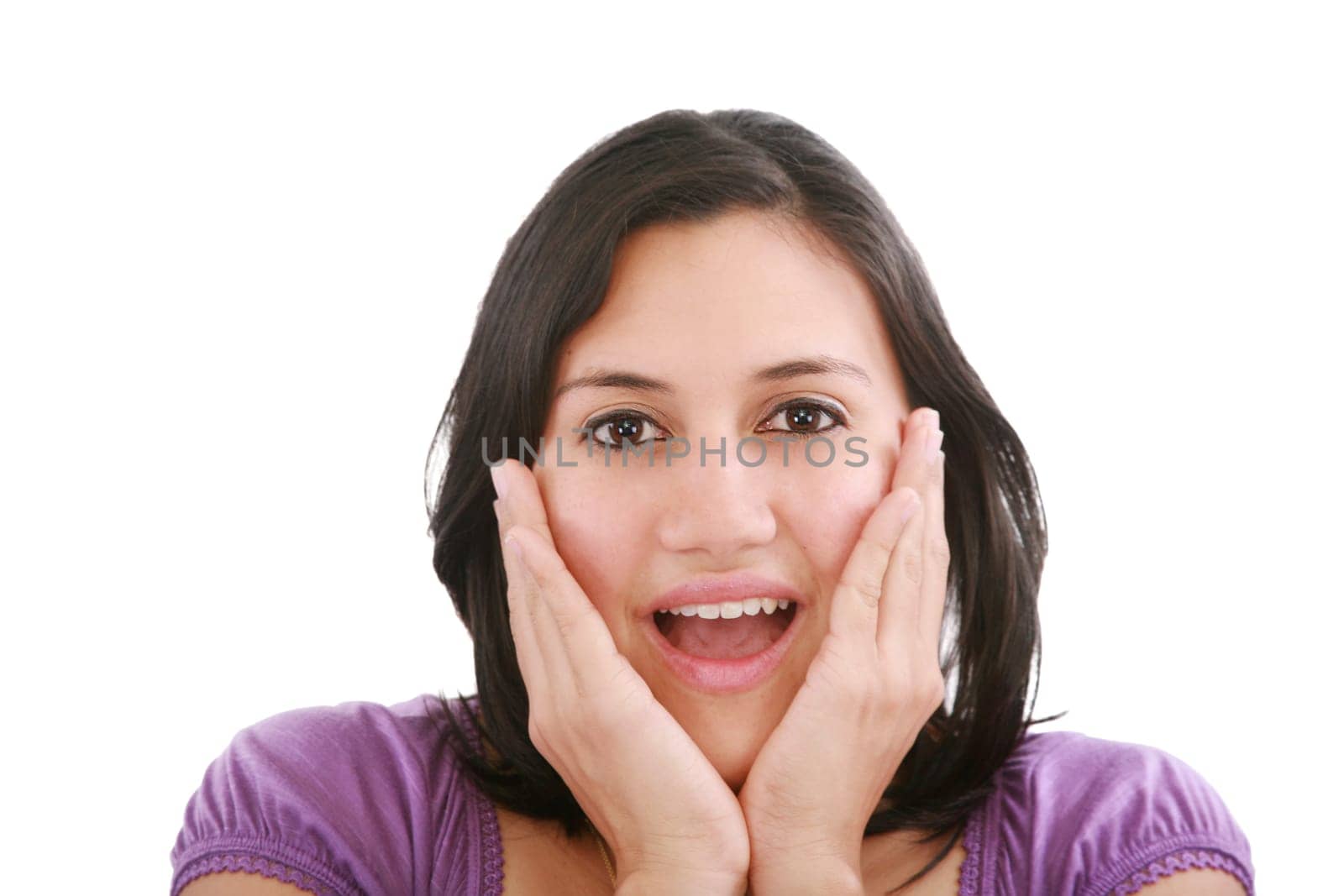 Portrait of young surprised girl holding her face